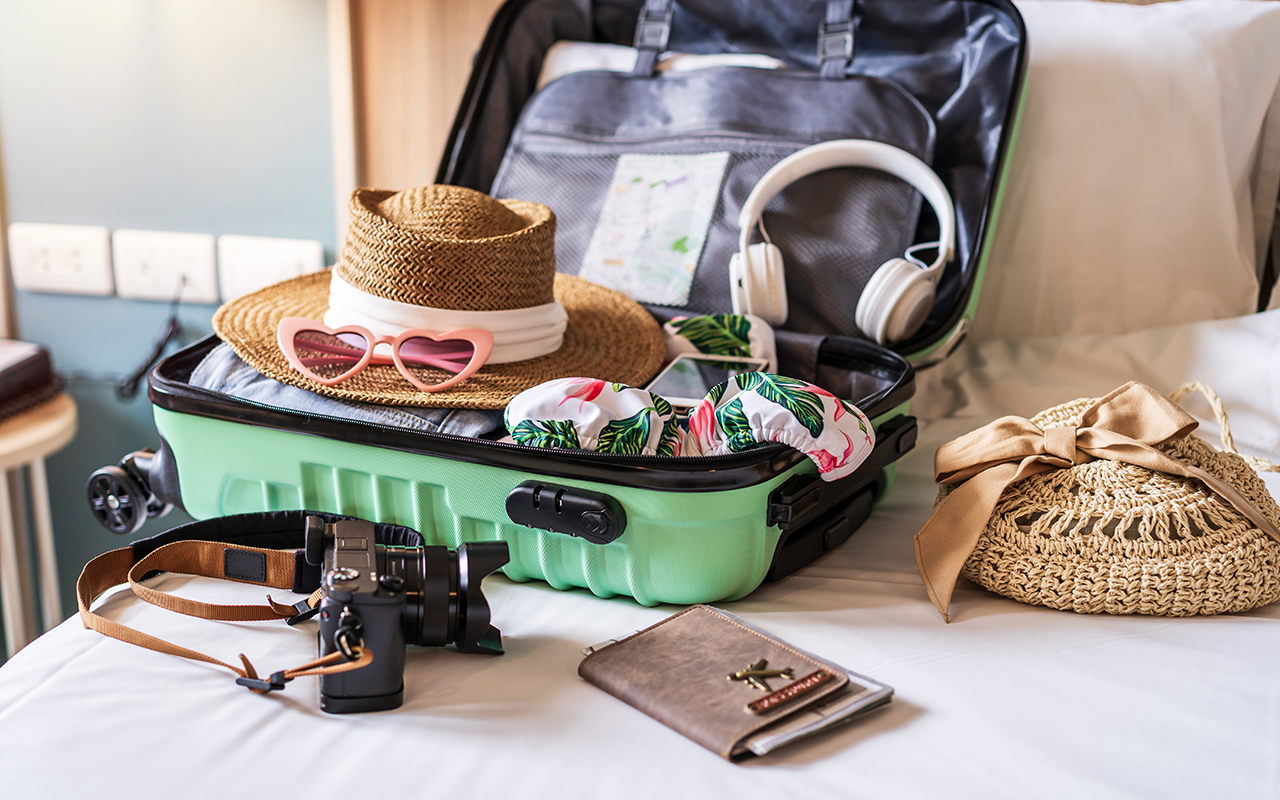 Traveler suitcase and luggage with travel accessories and items preparing for travel