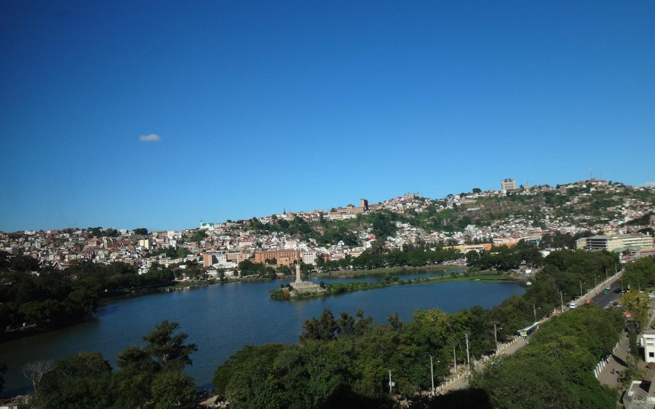 Aerial view of Antananarivo, Madagascar with hillside homes and city streets under a blue sky