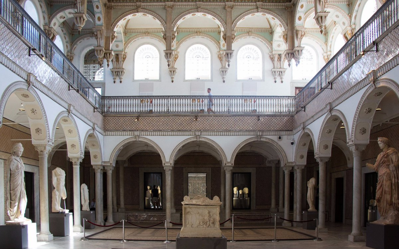 Arched hall of the Bardo National Museum in Tunis, Tunisia featuring Roman sculptures and historic architectural details under natural light