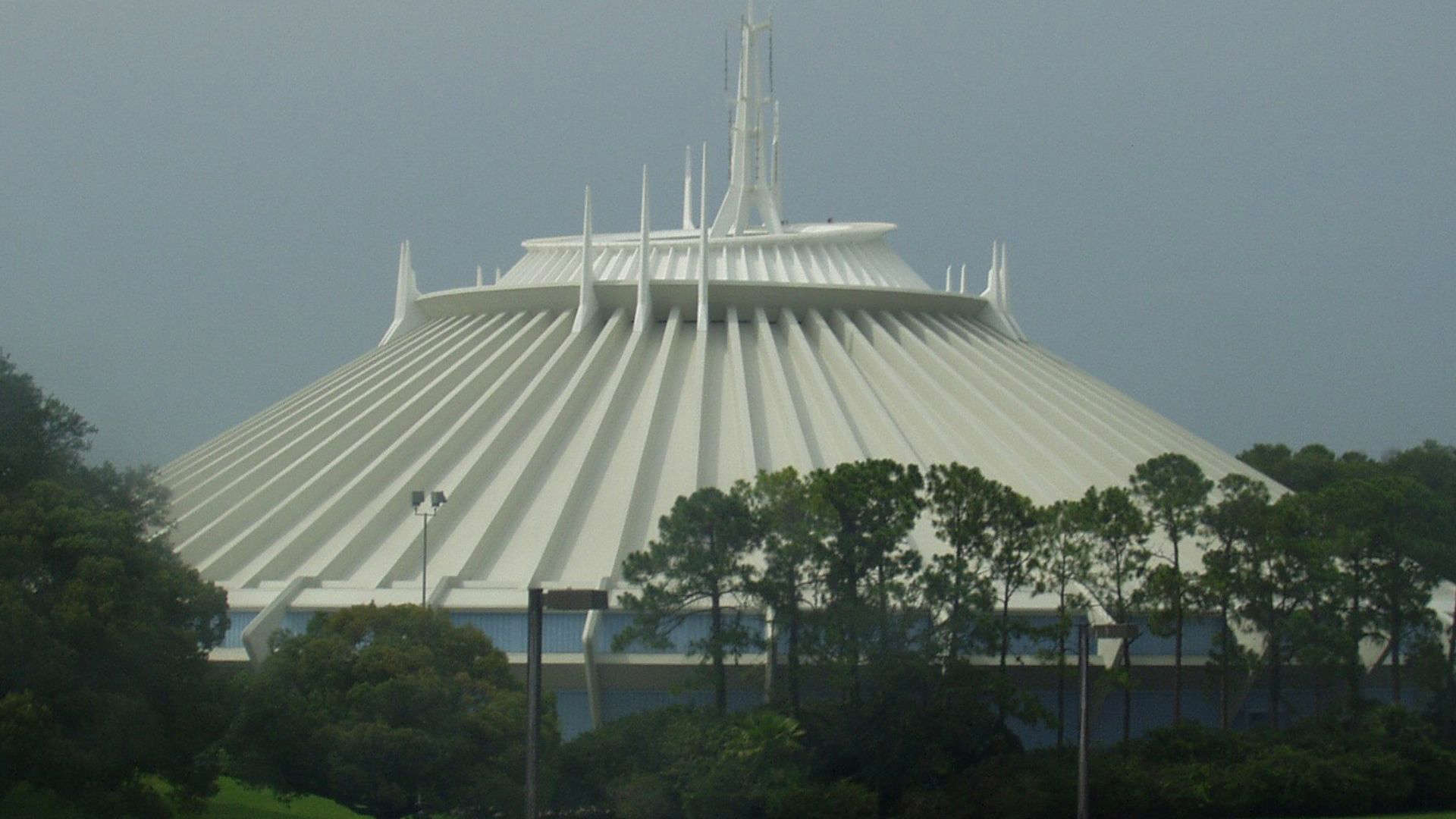 Futuristic white spired exterior of Disney’s Space Mountain, with its sleek, angular architecture resembling a space station or rocket launch pad.