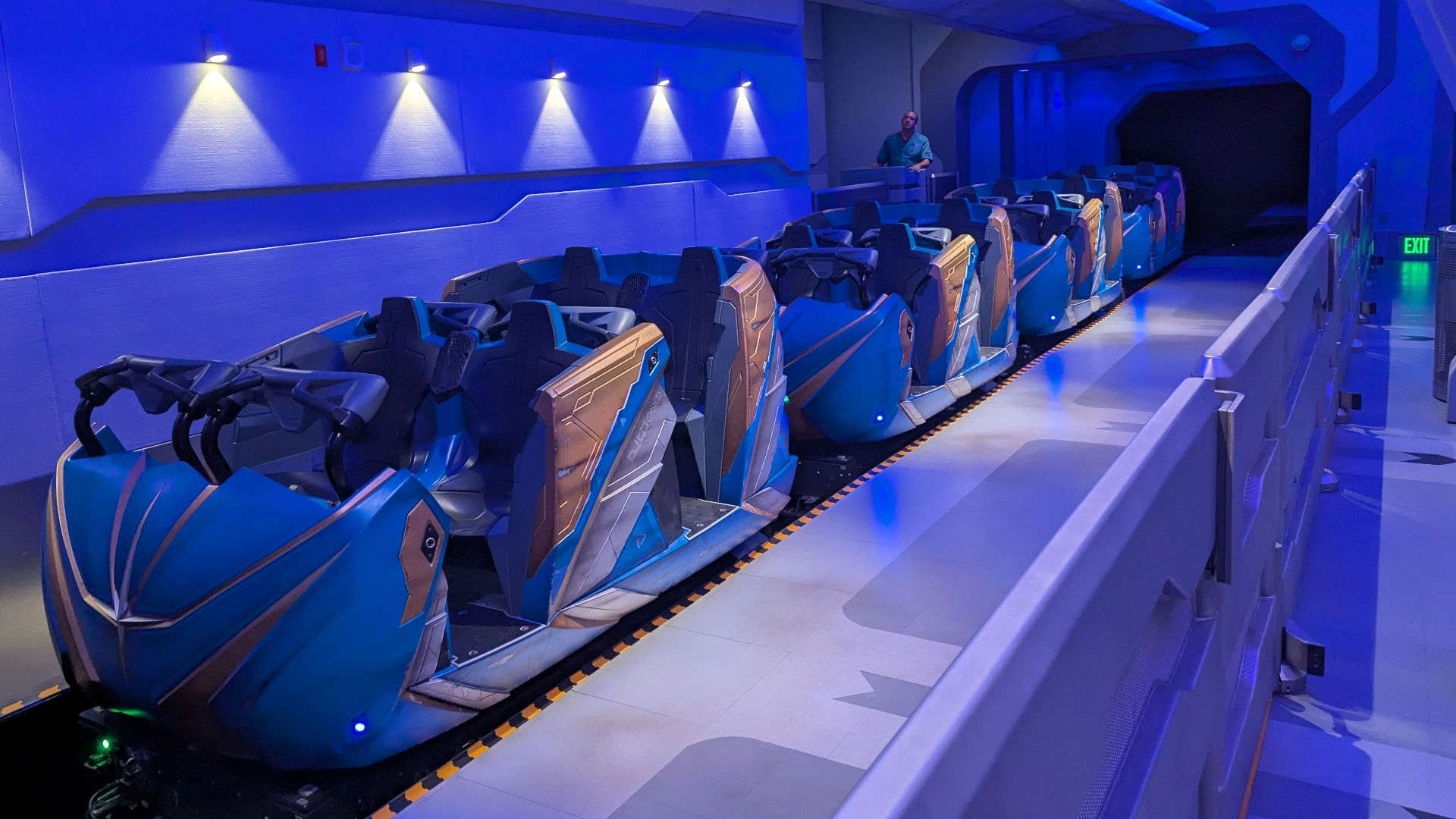 Guardians of the Galaxy: Cosmic Rewind at EPCOT, featuring a sleek, space-themed design with glowing blue lighting, futuristic panels, and ride vehicles lined up for boarding. The immersive sci-fi atmosphere sets the stage for the intergalactic adventure ahead.