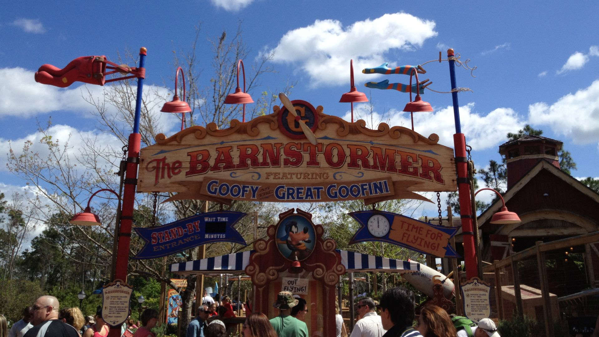 Entrance sign for Disney’s The Barnstormer featuring Goofy as the Great Goofini, with circus-style lettering and playful aviation theme.
