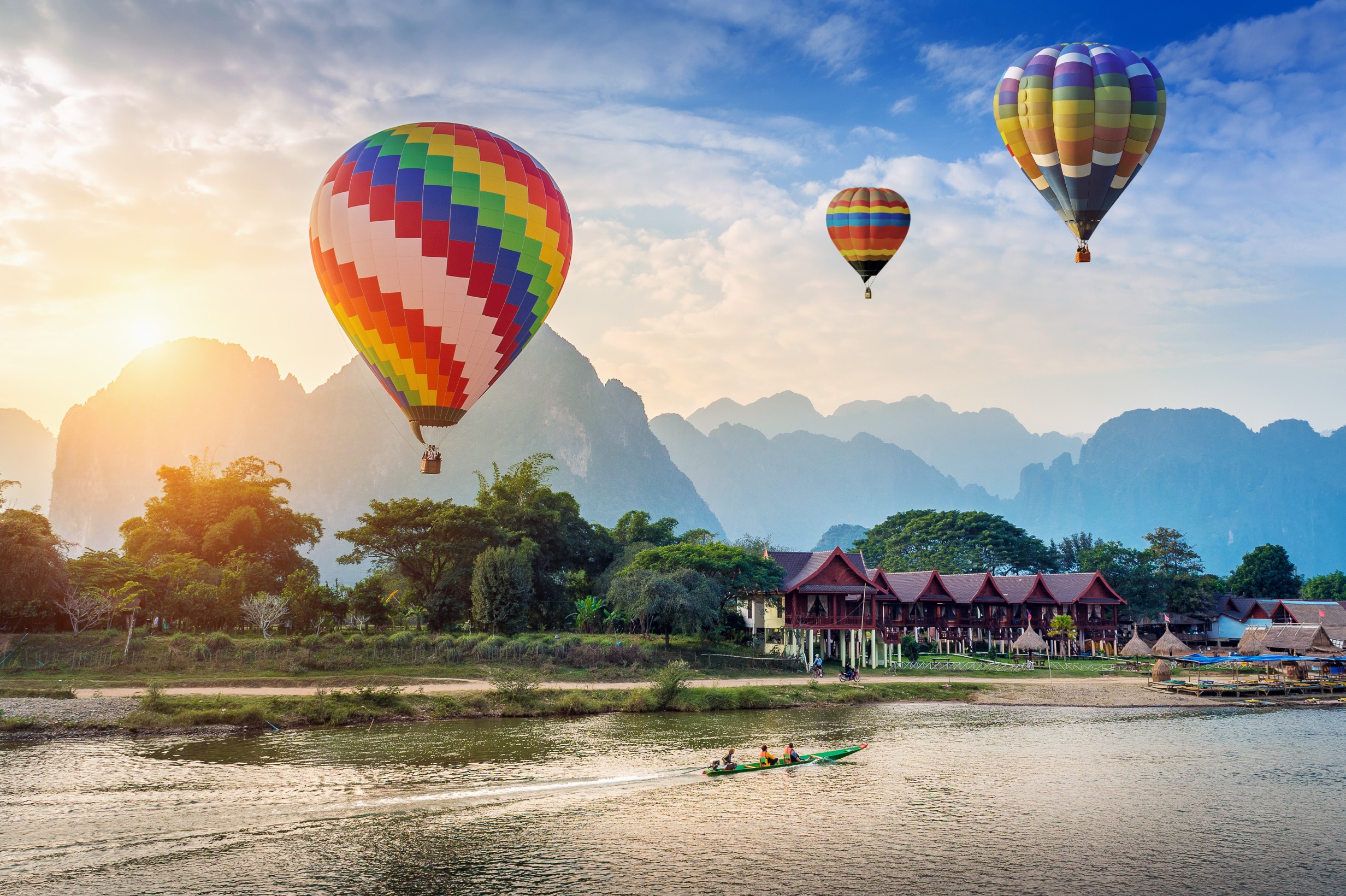 Hot air balloon over Nam Song river at sunset in Vang vieng, Laos.
