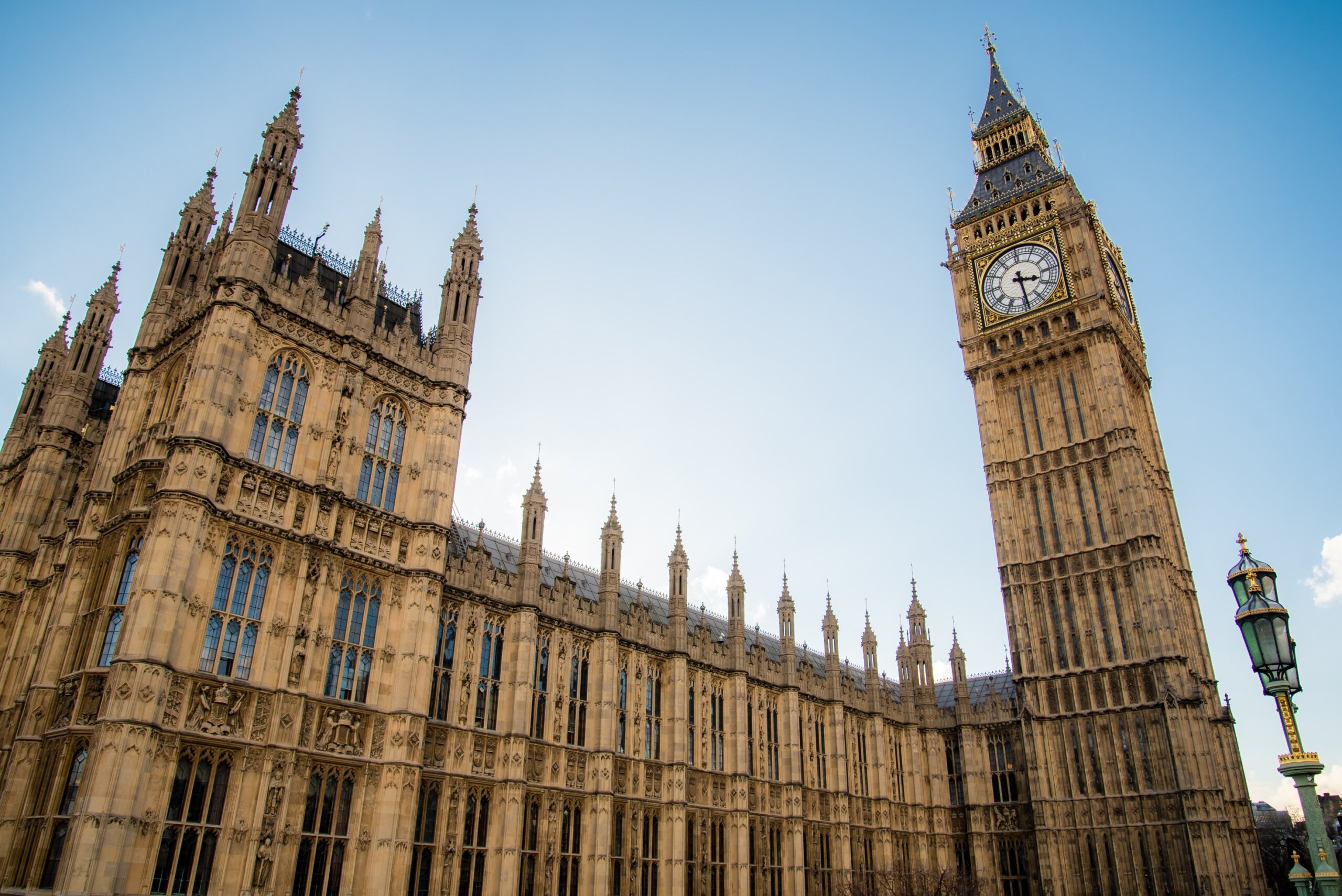 Wide angle close up of the Big Ben clock tower and the gorgeous architecture of the house of commons
