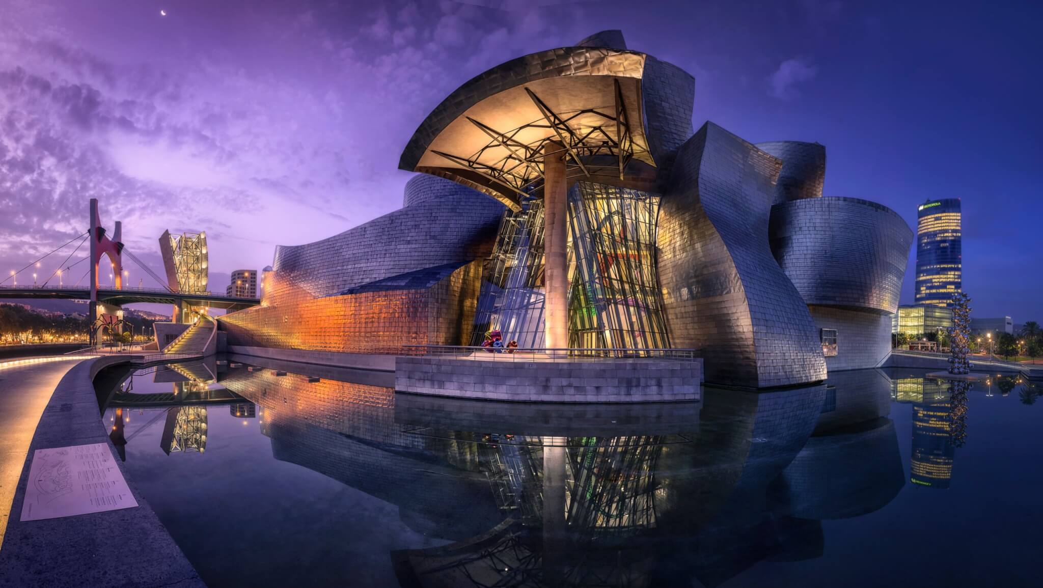 Magnificent panoramic view of the exterior facade of the Guggenheim Museum Bilbao at night
