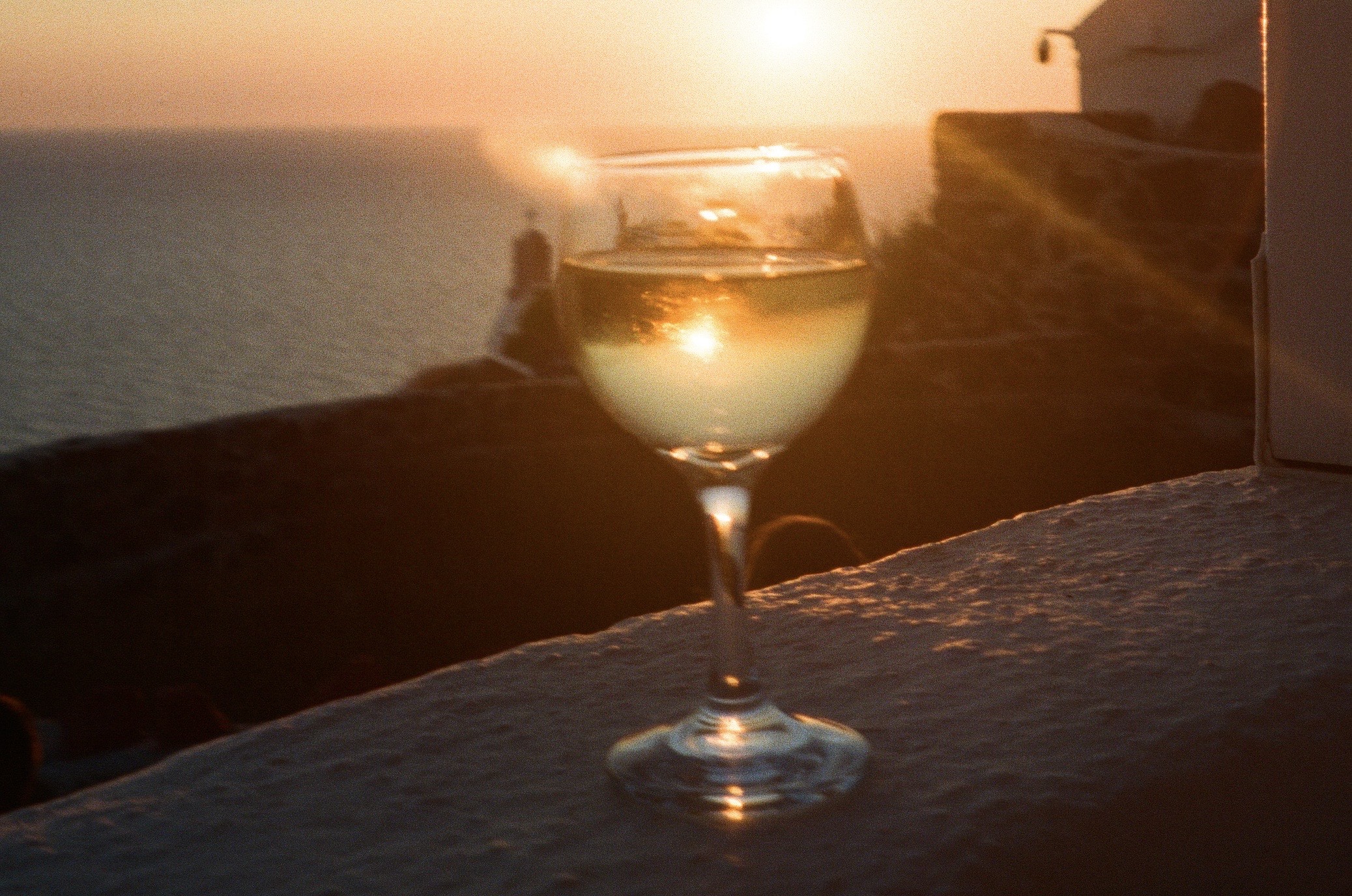 Greek wine enjoyed in front of a sunset on the Greek islands 