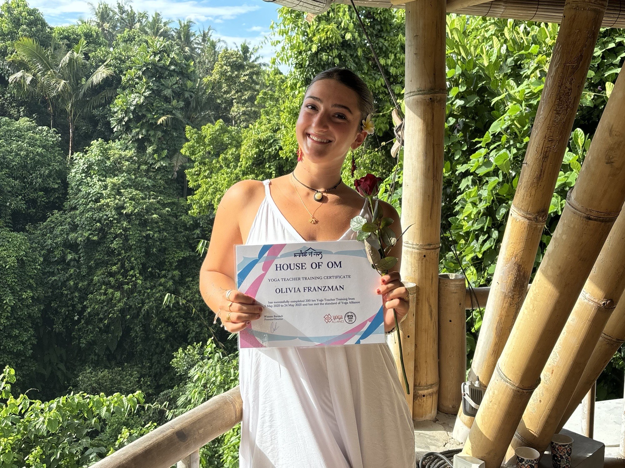 Olivia with yoga training certificate