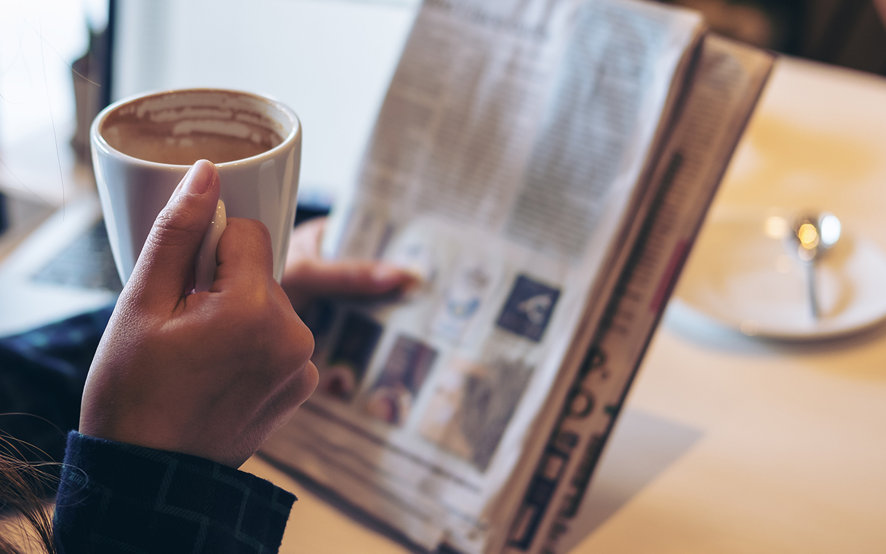 Cup of coffee and newspaper