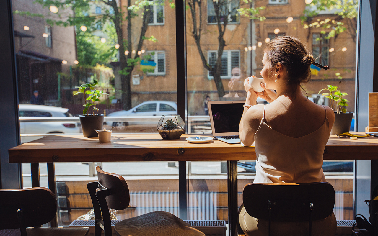 Woman in a cafe with a laptop