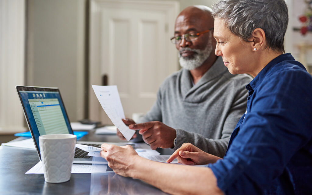 Elderly couple looking over financial papers