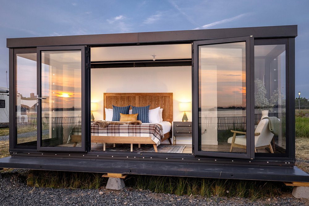 Modern luxury glamping cabin in New York with sunset view and glass walls