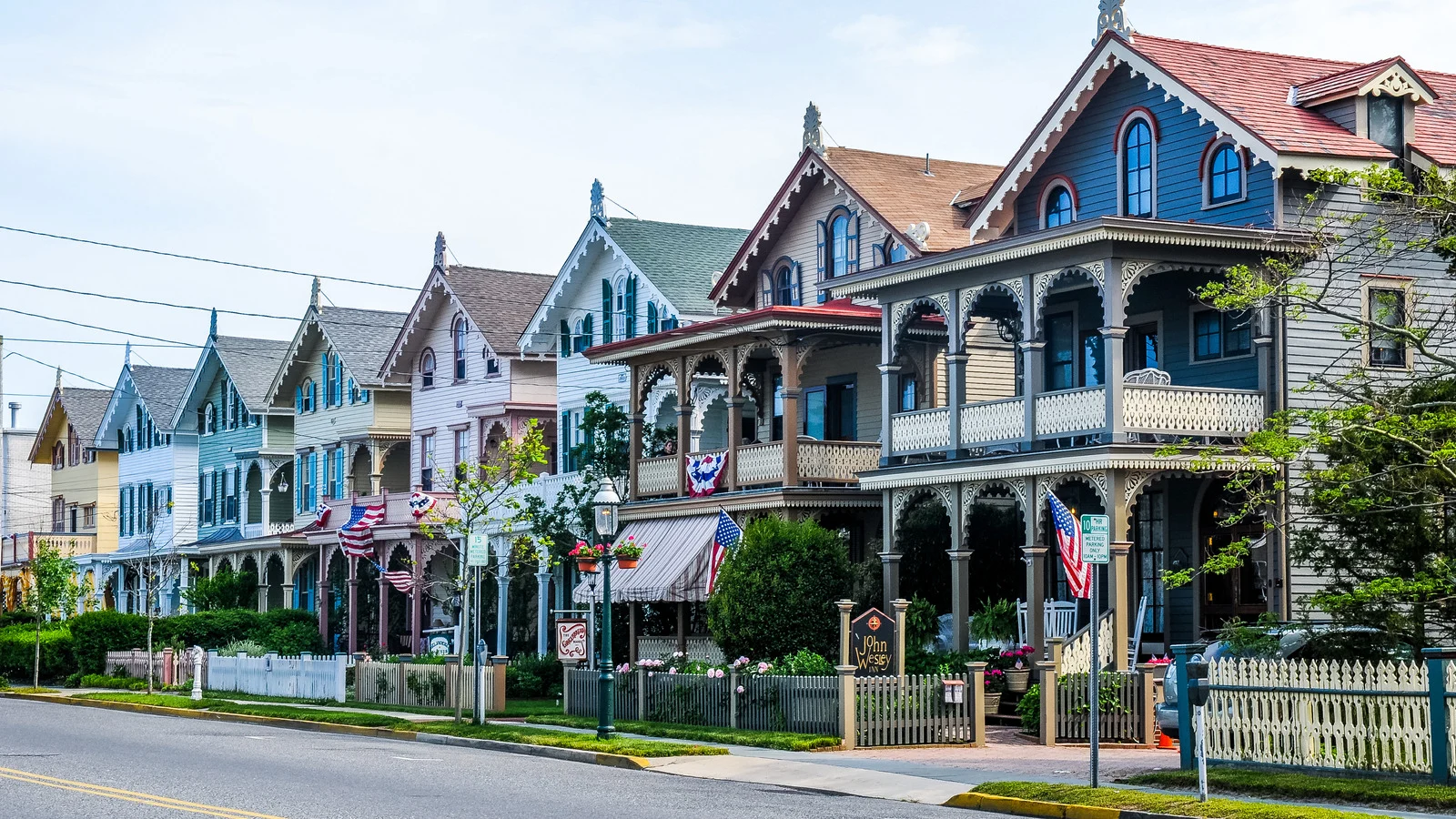Charming Victorian-style homes in Cape May, New Jersey, with colorful facades, ornate trim, and wraparound porches under a sunny sky.