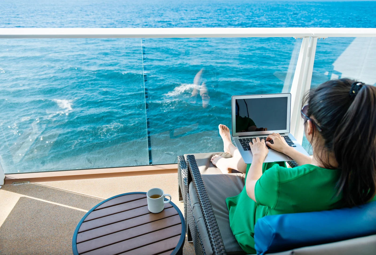 Woman using a laptop on a cruise ship