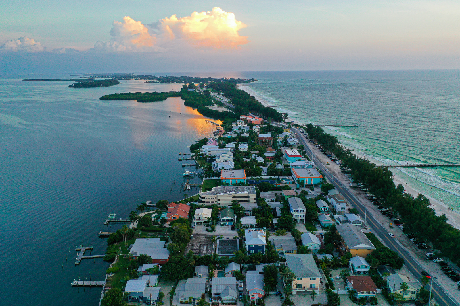Aerial view of Anna Maria Island, Florida, showcasing turquoise Gulf waters, white sandy beaches, and a charming coastal town nestled along the shoreline.