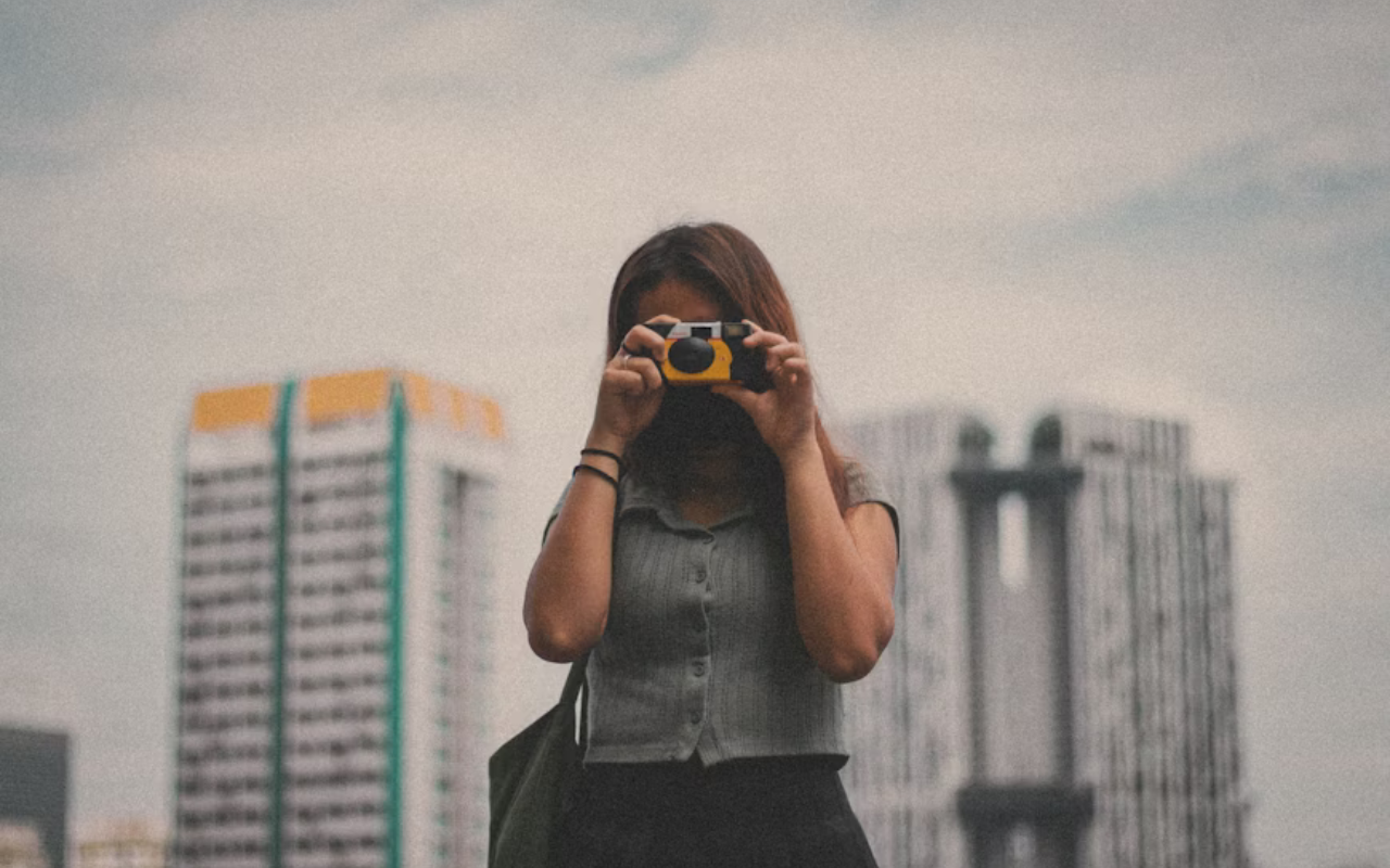 Woman taking a photo on a disposable camera