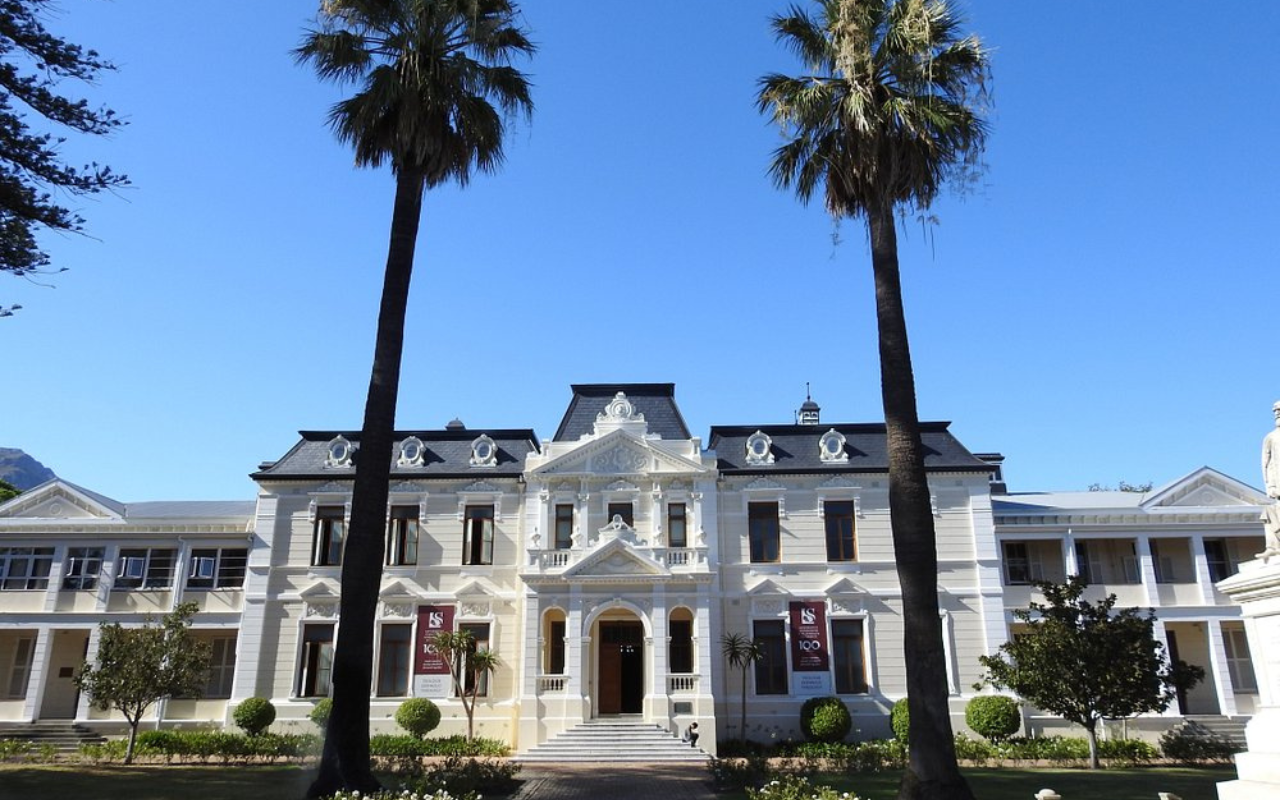 Front face of a law university house or hoofgebou in evening hours in stellenbosch downtown, south africa. Lovely collonial building backlit by evening sun