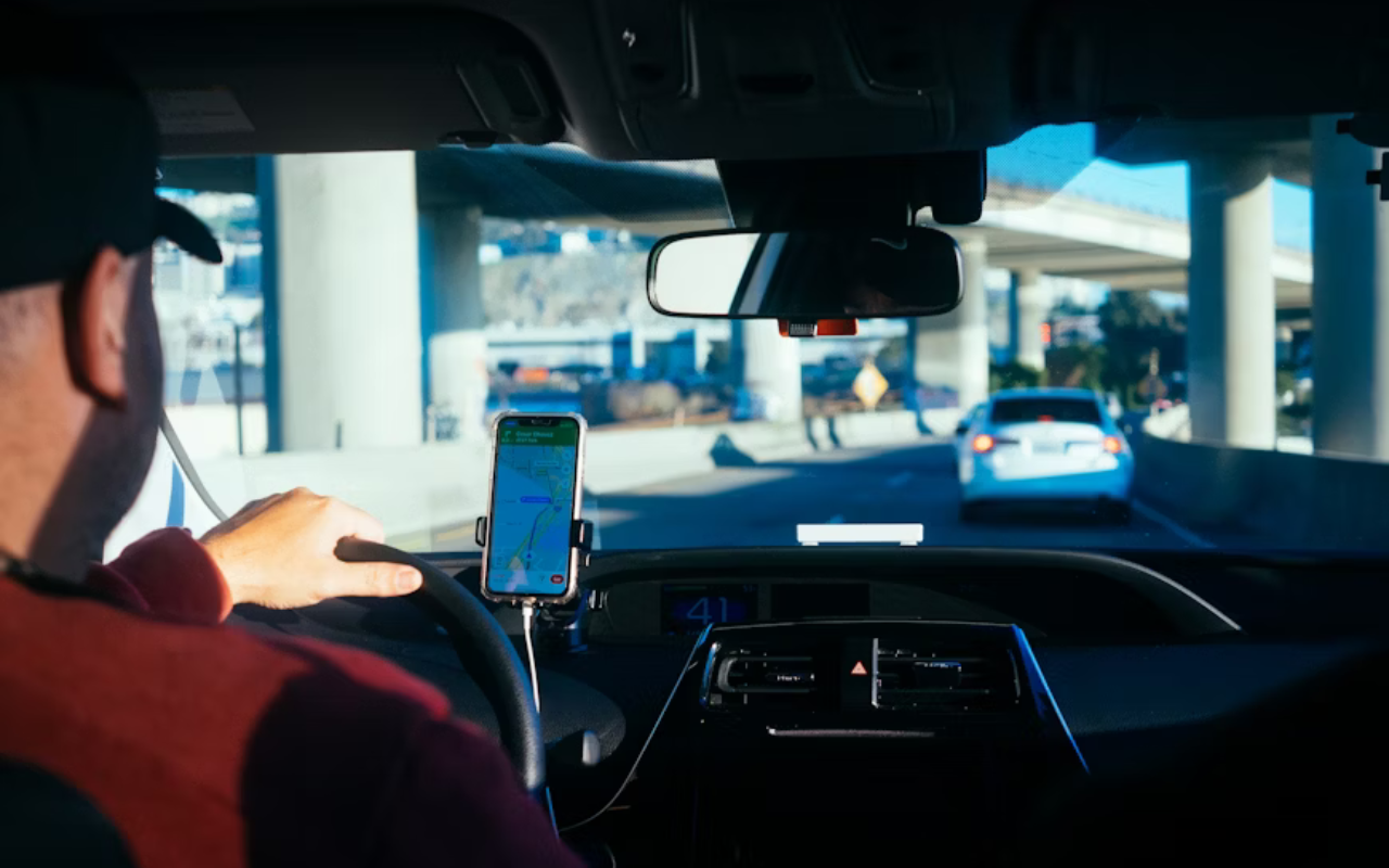 Man driving in a city using google maps for directions