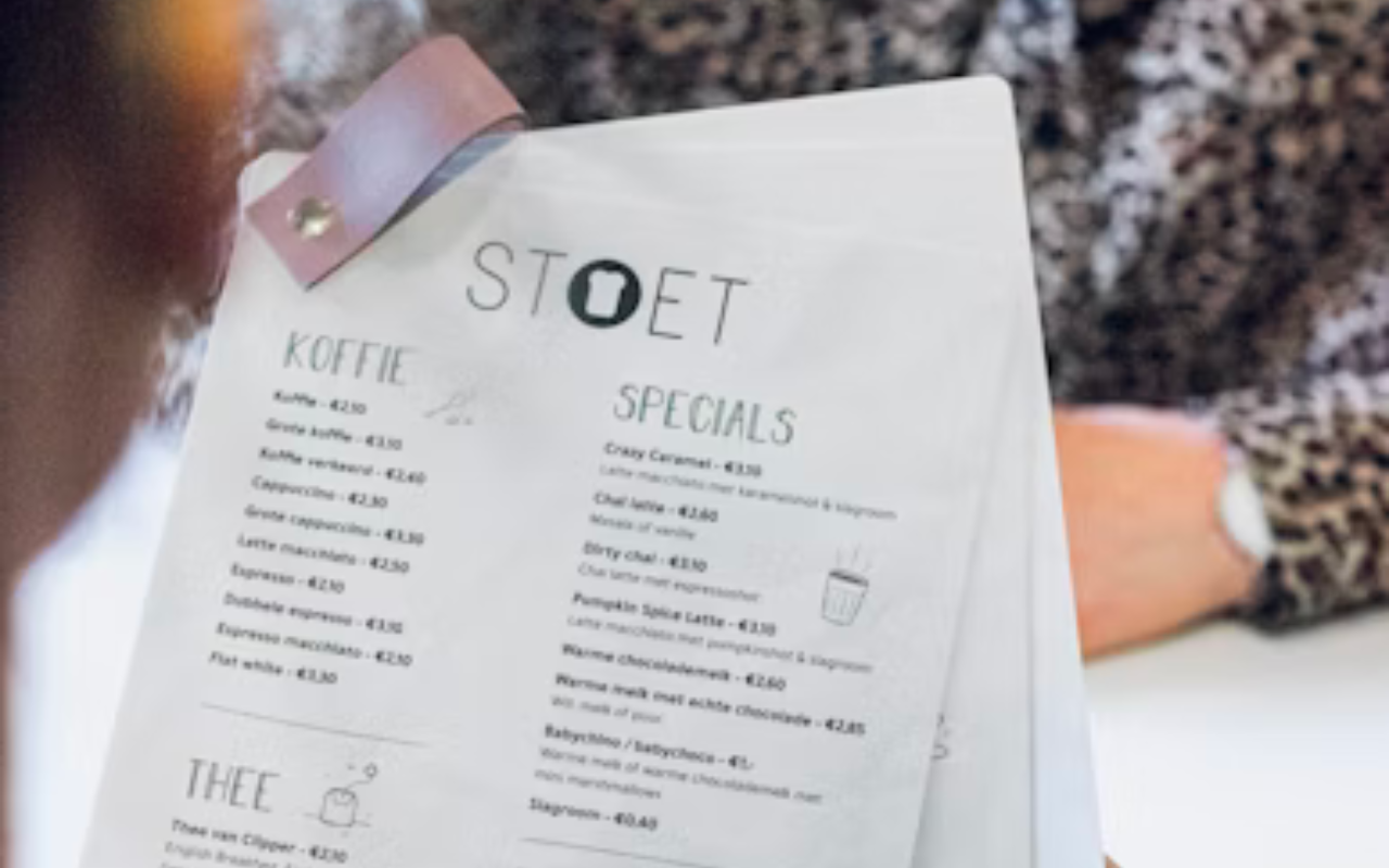 Man looks over the menu at a restaurant