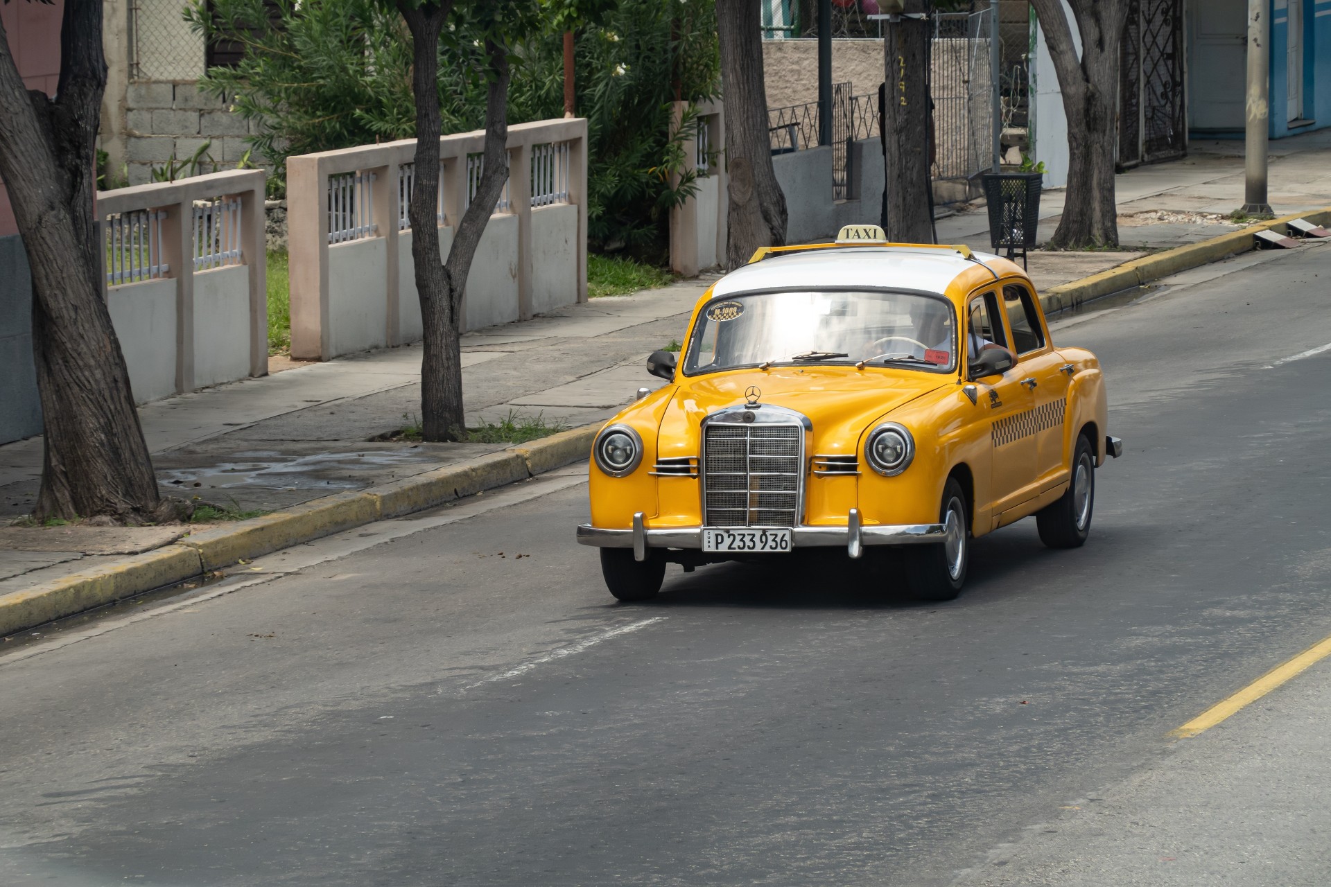 Yellow Mercedes-Benz 180 W120 taxi car in streets of Varadero, Cuba