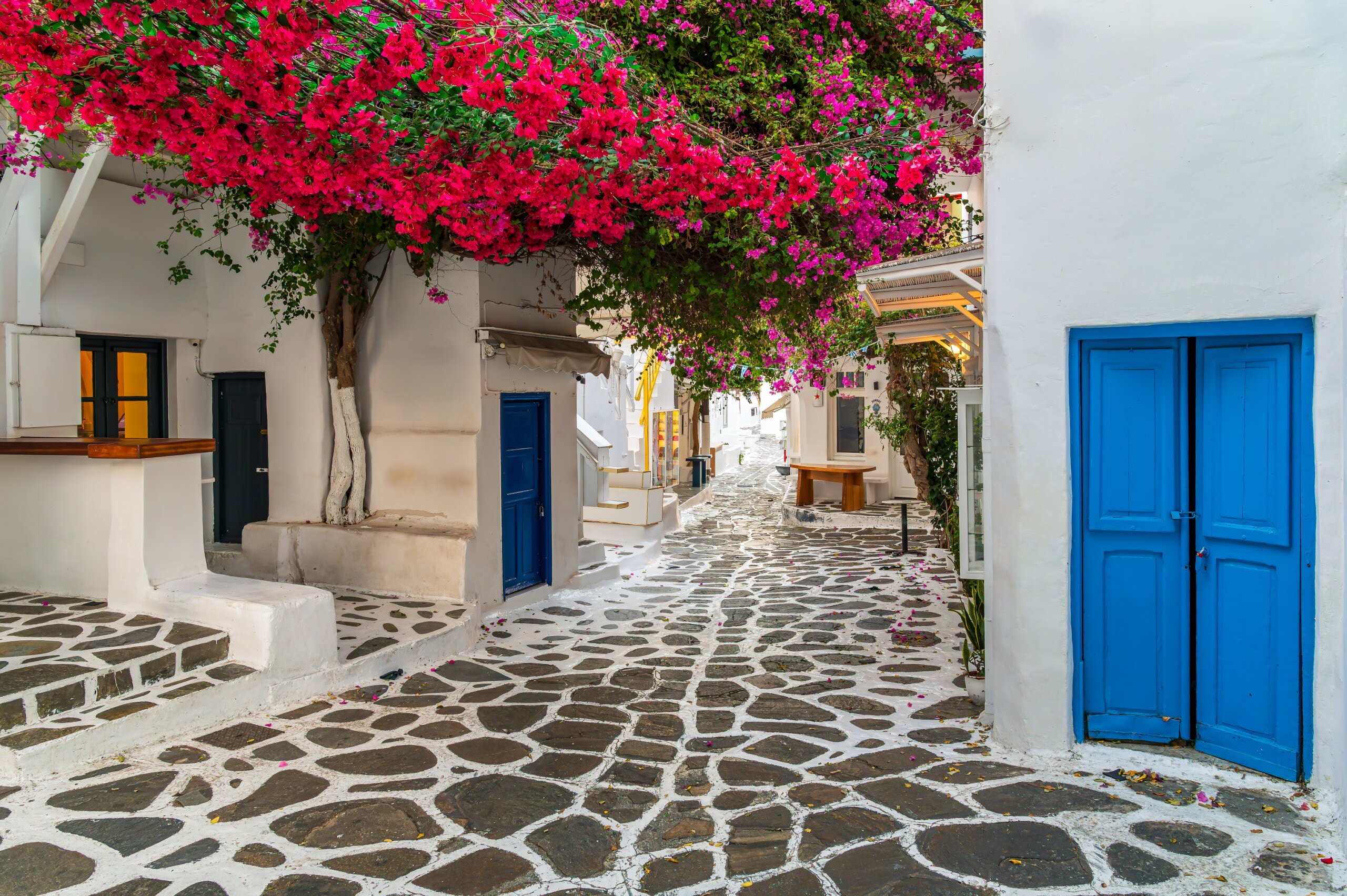 Scenic view of Mykonos Town (Chora) on Mykonos Island, Cyclades, Greece, featuring traditional whitewashed buildings by the sea.