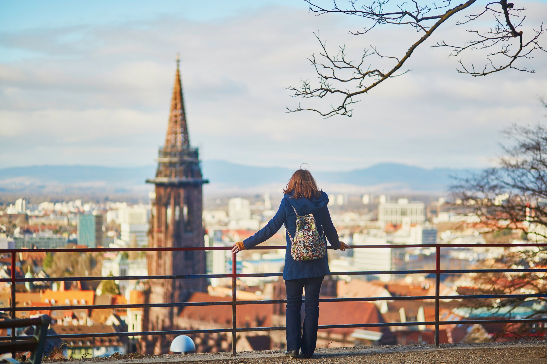Girl enjoying panorama of Freiburg im Breisgau in Germany