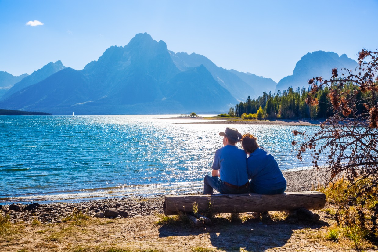 Couple watching sunset at Grand Teton National Park Wyoming – romantic mountain honeymoon destination USA 2025