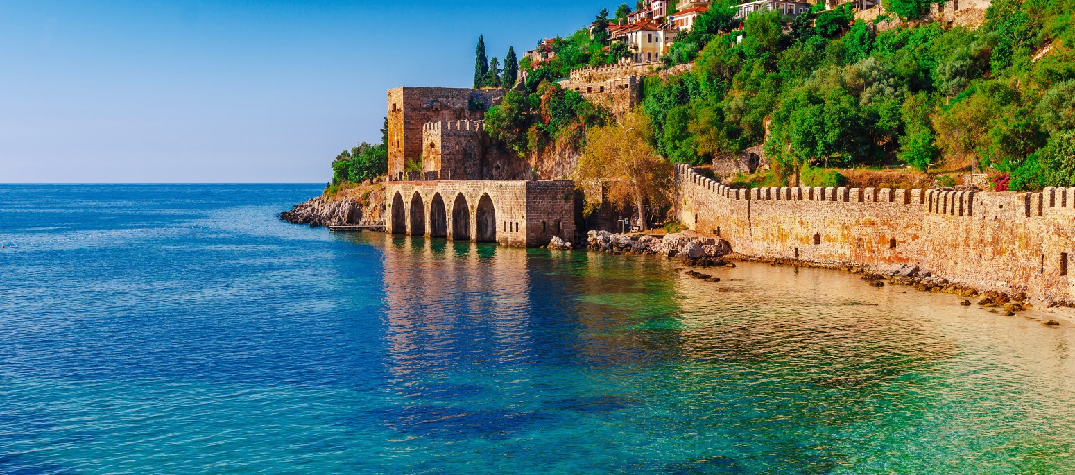 Landscape of ancient shipyard near of Kizil Kule tower in Alanya peninsula, Antalya district, Turkey, Asia. Famous tourist destination with high mountains. Part of ancient old Castle