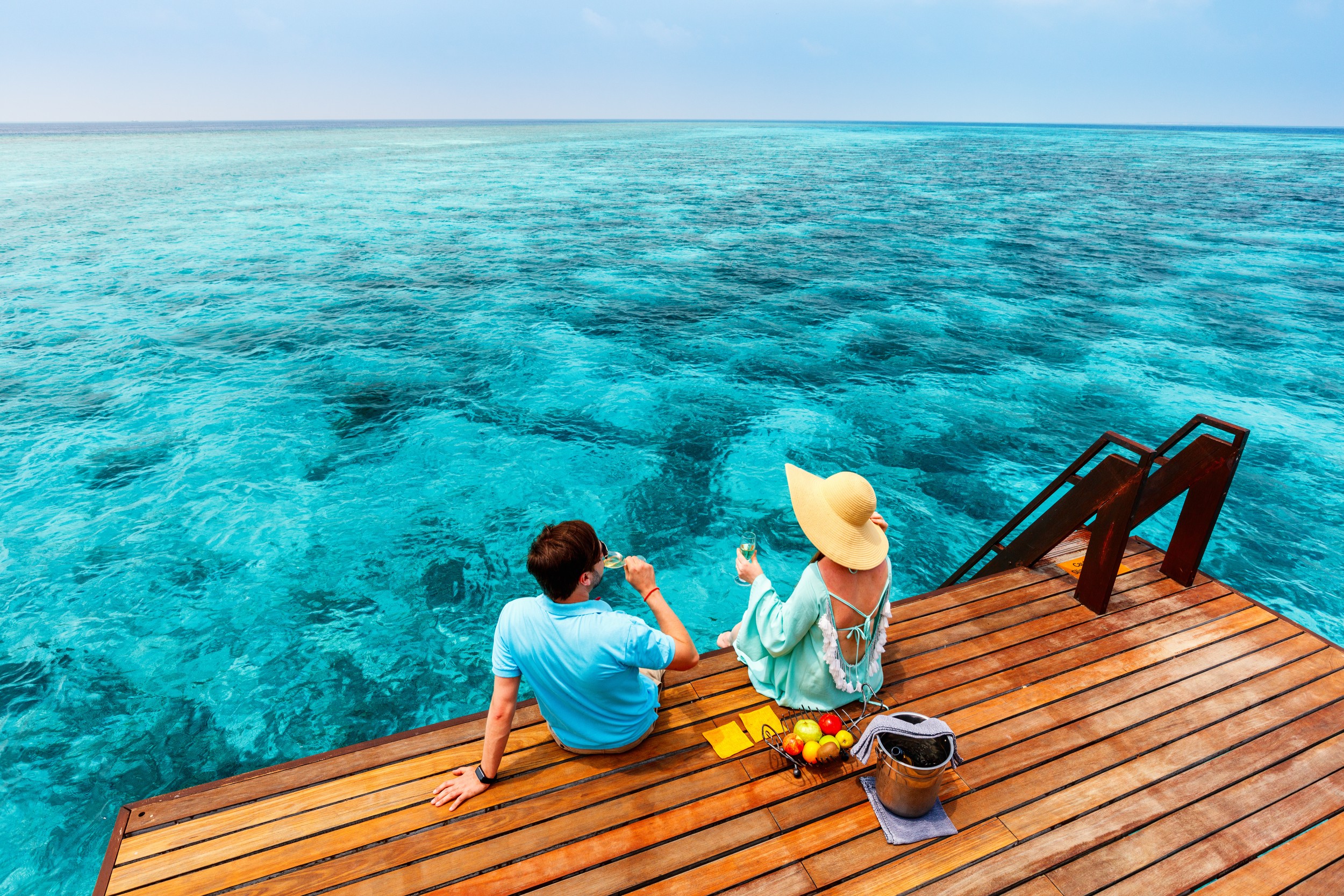 Couple at tropical luxury resort in Maldives on honeymoon – top romantic luxury honeymoon destinations 2025