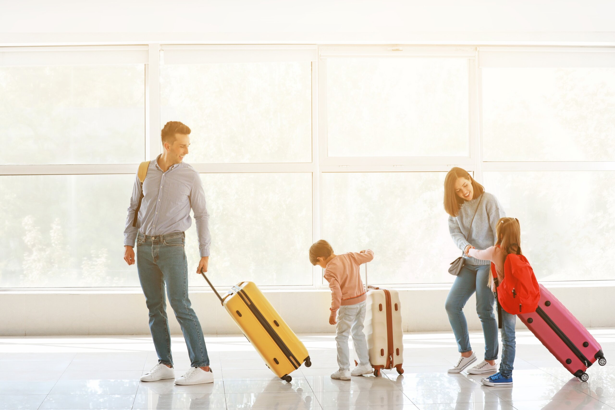 Family with luggage walking through airport during Labor Day travel weekend