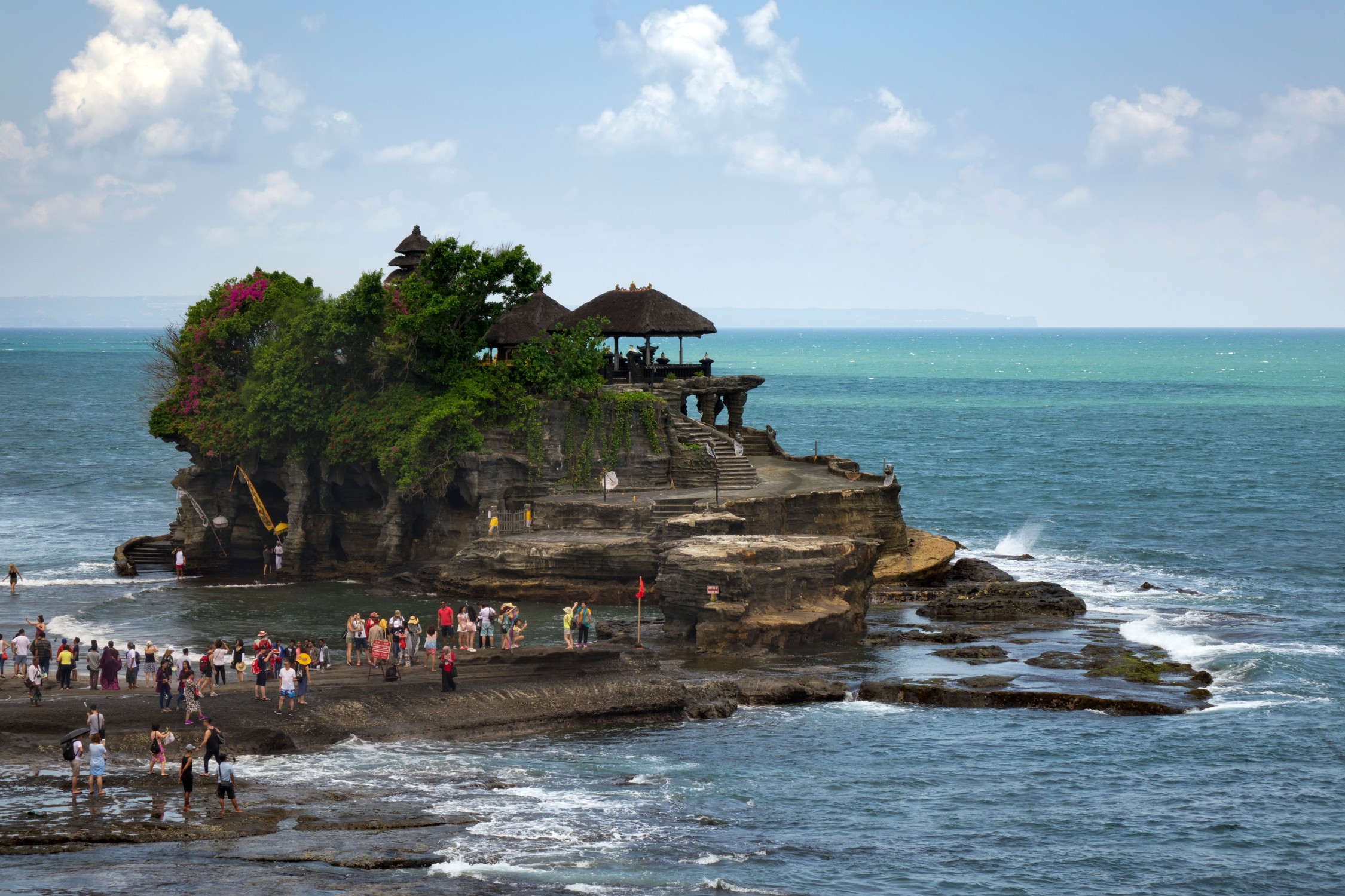 Crowds of tourists at Tanah Lot water temple in Bali Indonesia – example of overrated travel destination