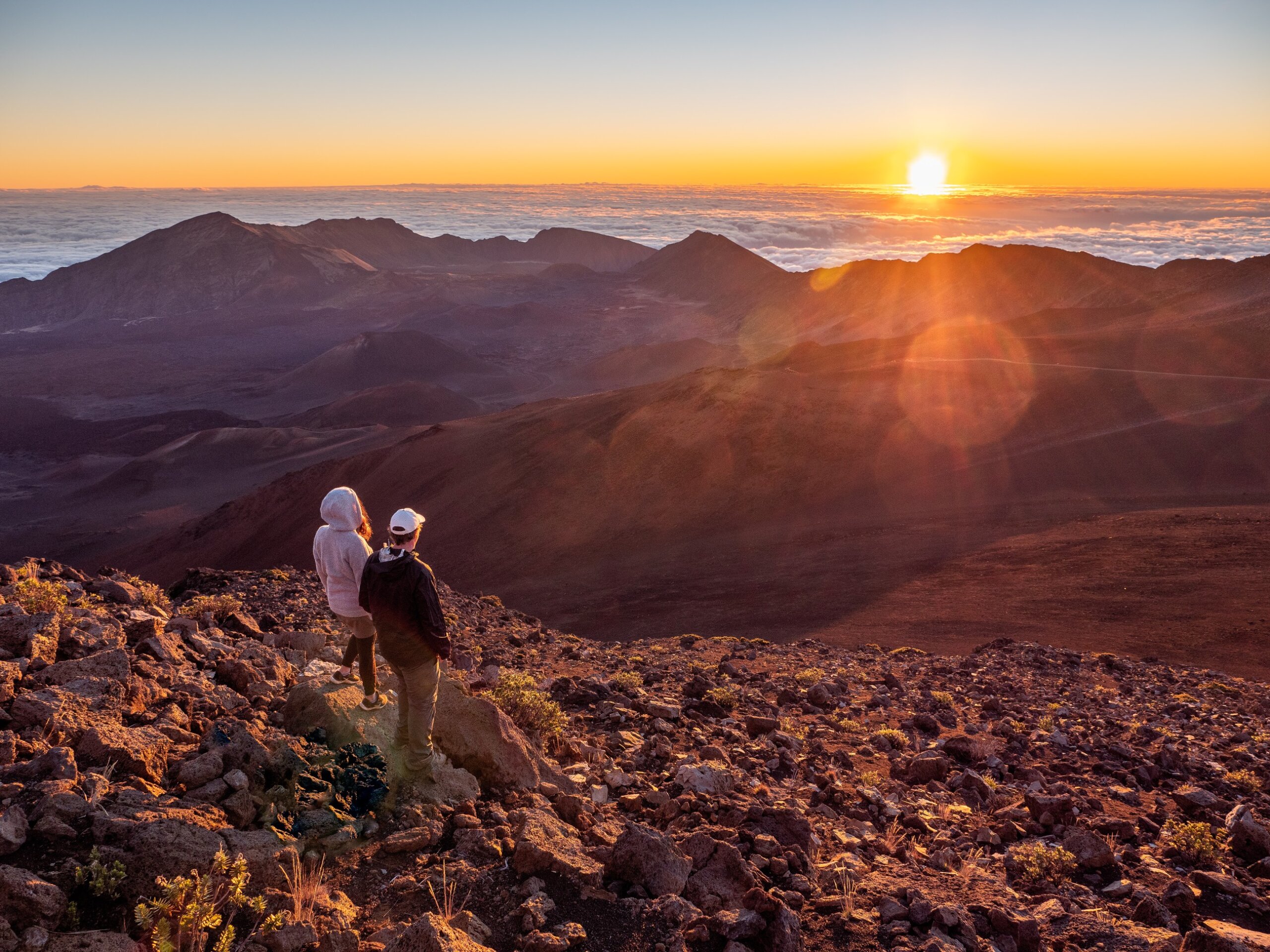 Couple watching sunrise at Haleakalā National Park Maui Hawaii – top romantic honeymoon destination USA 2025