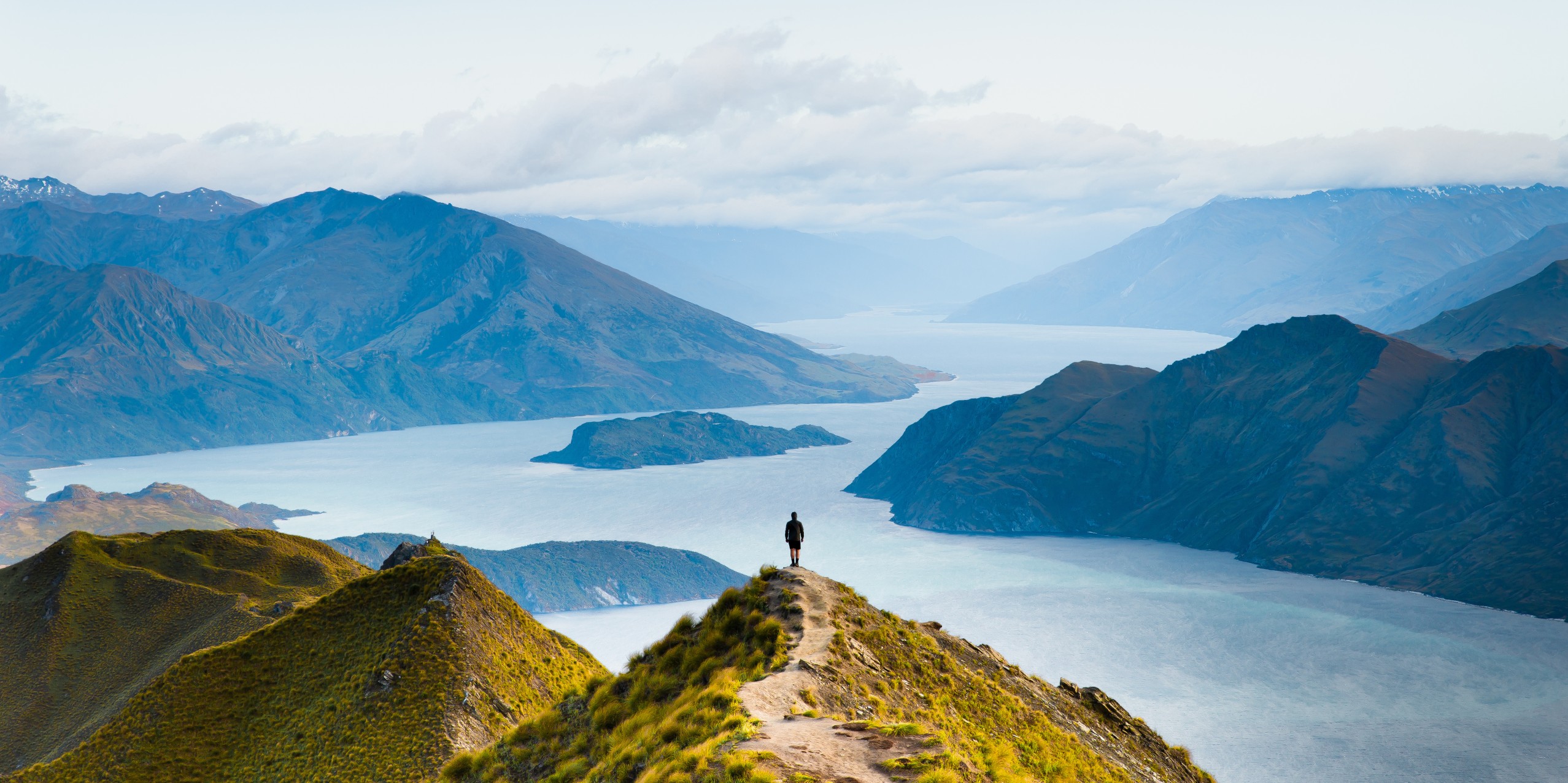 View from Roys Peak mountain hike in Wanaka, New Zealand, a popular travel destination for hiking and adventure tourism.