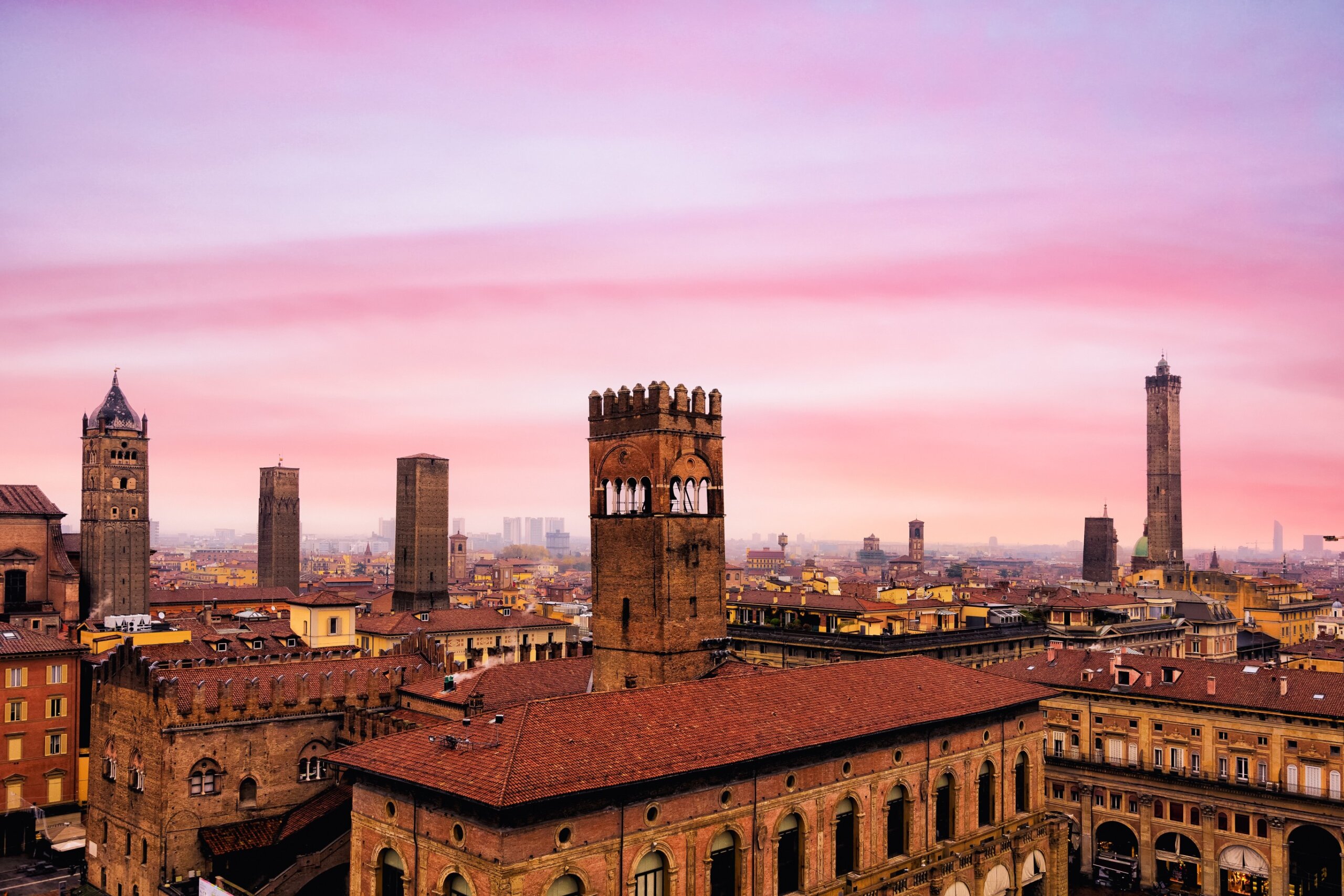 Top view from the drone of Via Indipendenza in the city of Bologna at sunset. Best city in Italy Europe in 2022. Wonderful romantic panorama of old city. University, art, cuisine.