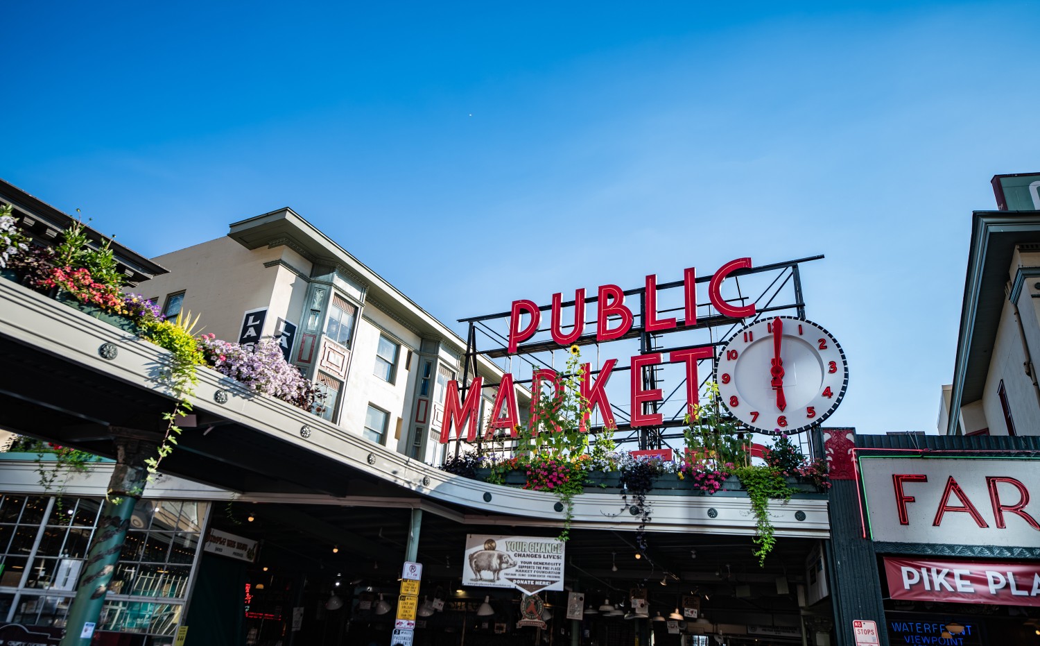 Pike Place Market as seen from Pike street on the sidewalk in Seattle, Washington on a clear sunny summer day