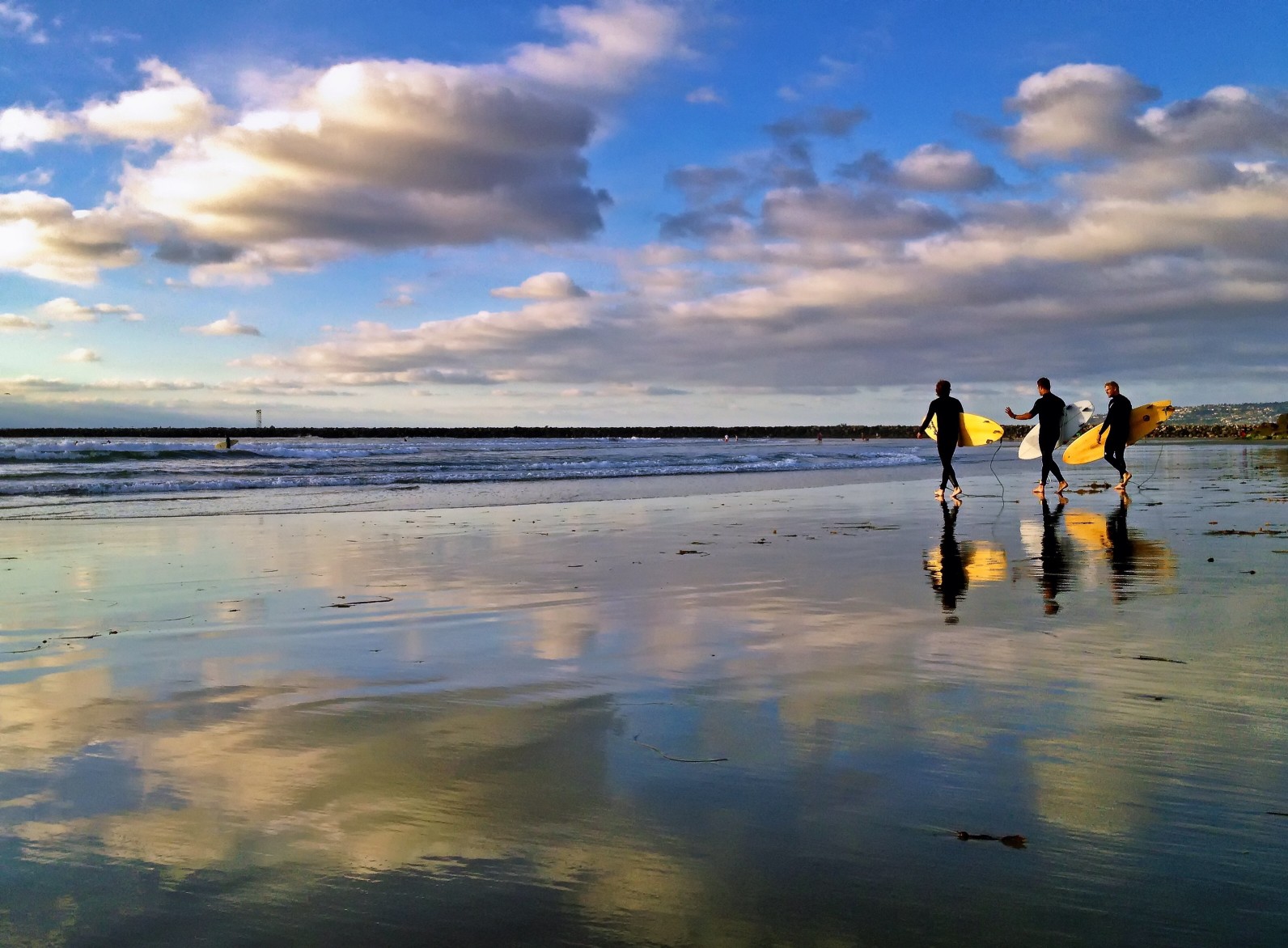 Three Surfers at Dog Beach, Ocean Beach, San Diego, CA, USA