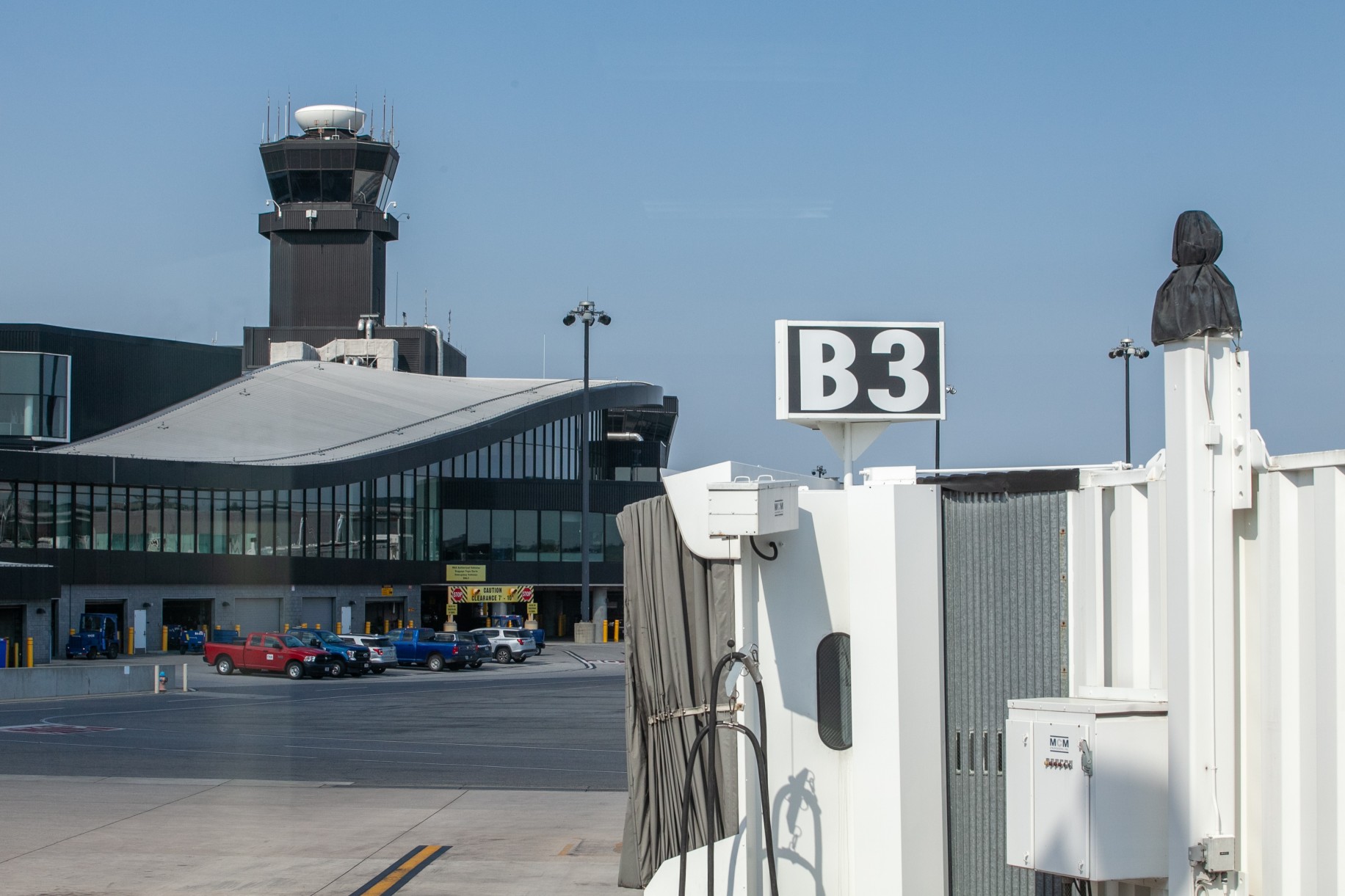 Passenger loading bridge with control tower at Baltimore/Washington International Airport during Labor Day travel