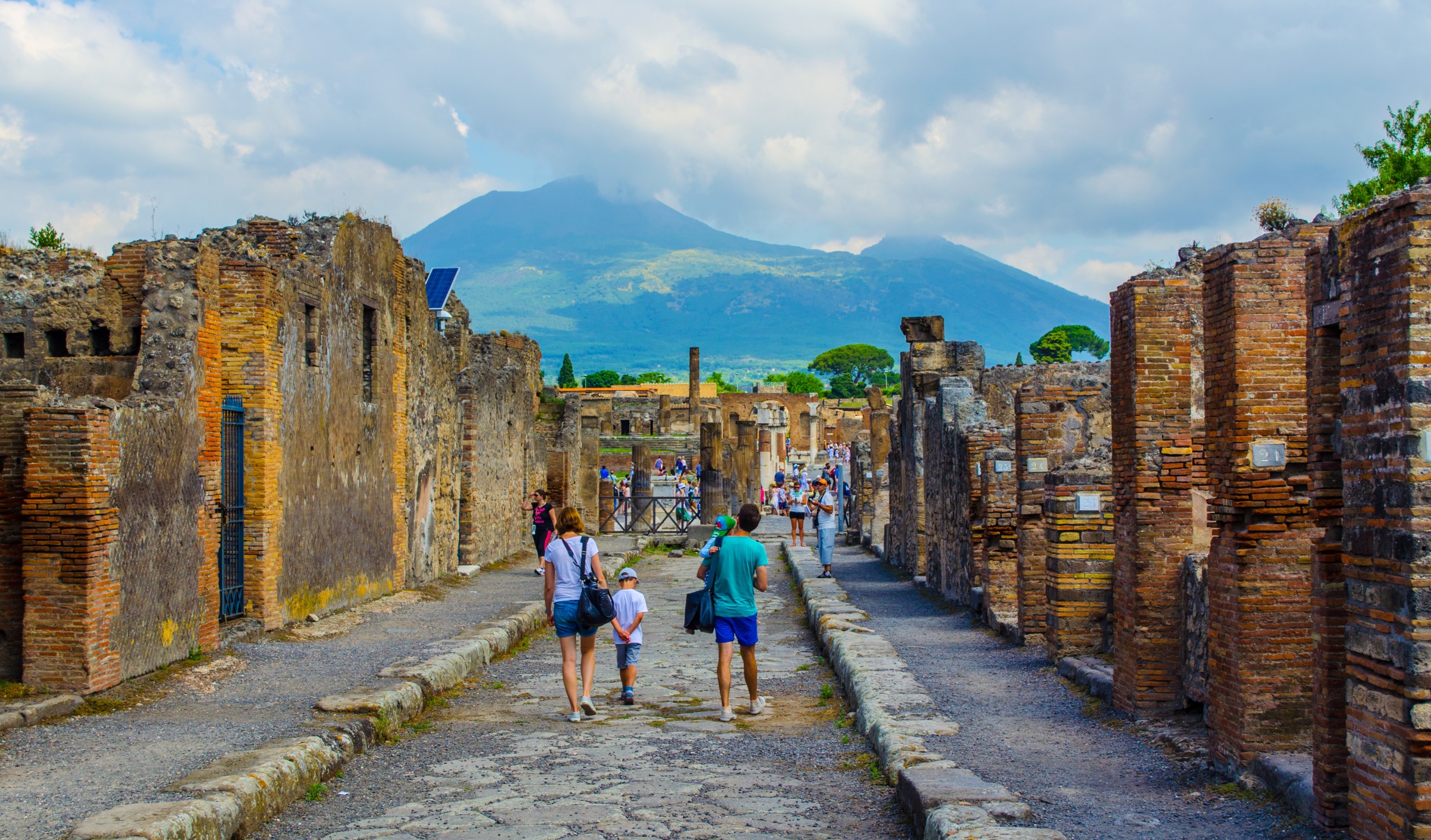 Visitors walking through the ancient ruins of Pompeii, a UNESCO World Heritage Site in Italy.