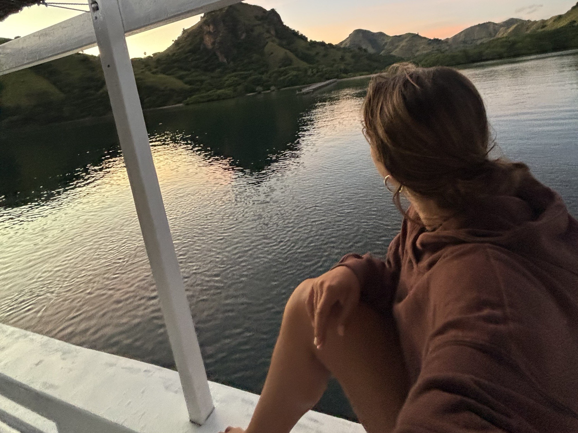 Olivia enjoying the early morning views of the mountainous islands from the boat.