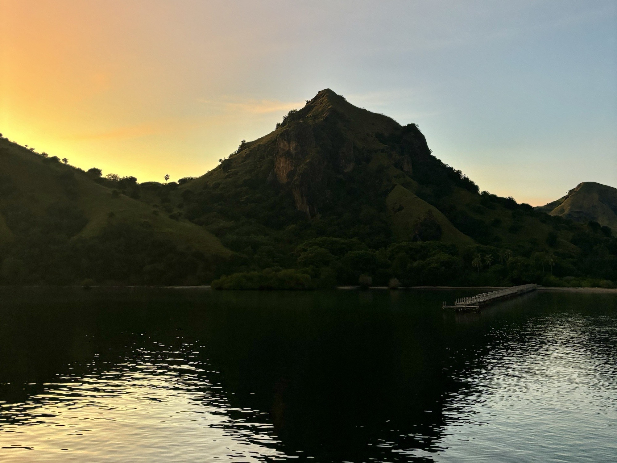 Surrounding Mountain Views at sunrise taken by a traveler on a boat tour.