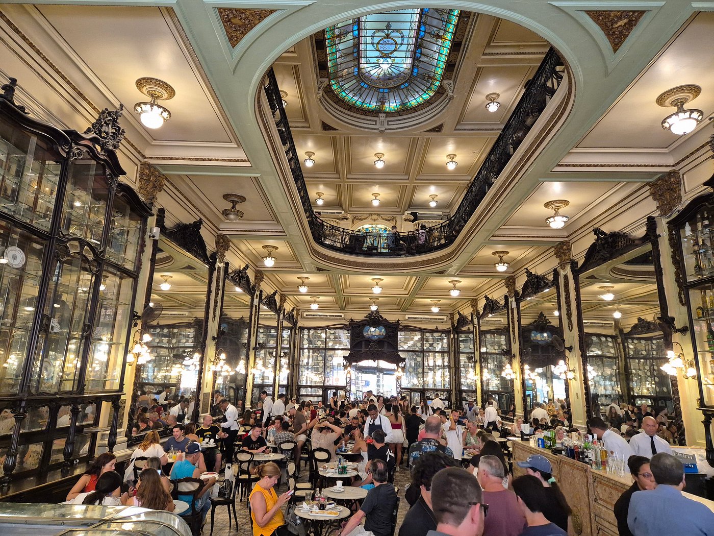 Rio café with Belle Époque design, stained-glass skylight, and antique mirrors.