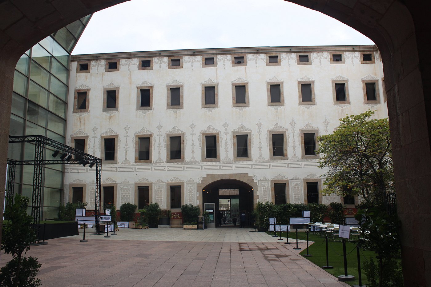 Modern glass-fronted courtyard at the Centre de Cultura Contemporània de Barcelona hosting cultural exhibitions and events.