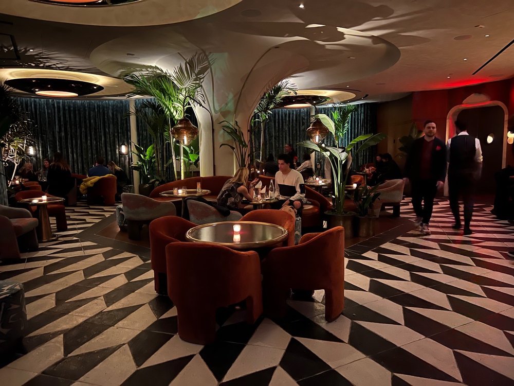 Interior of Chez Zou bar in New York City – tropical-themed modern cocktail bar with bold colors and stylish seating