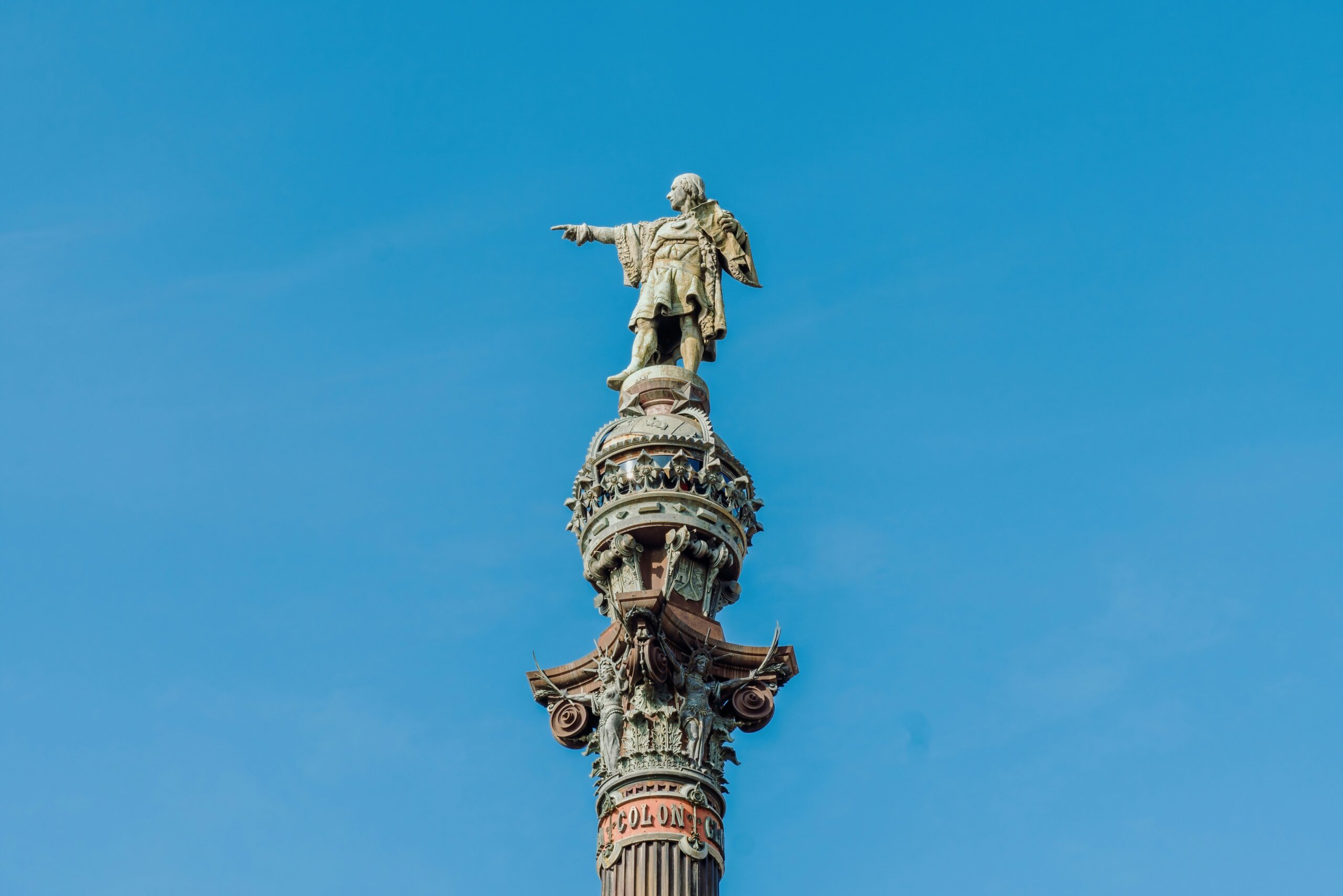 Christopher Columbus Monument in Barcelona with towering column and panoramic city and sea views from the top.