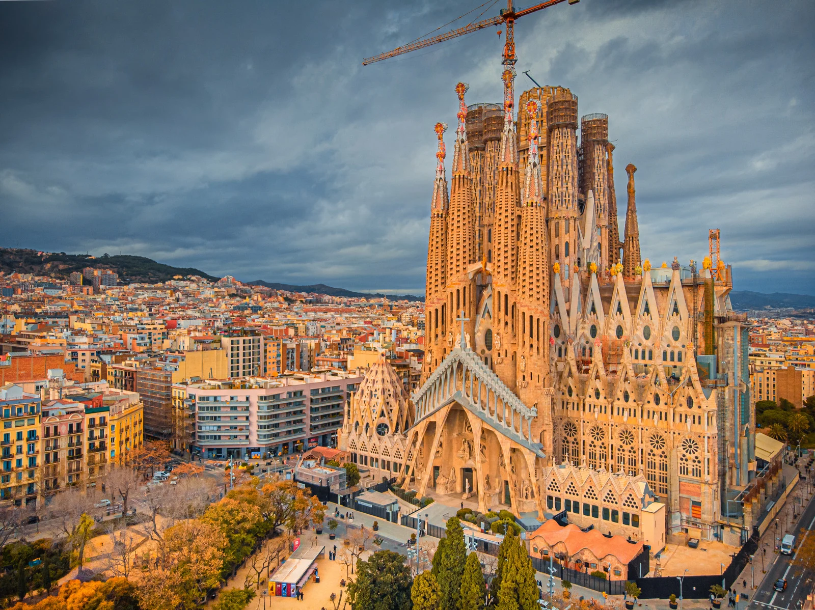 Sagrada Família basilica in Barcelona with towering spires, intricate facades, and colorful stained-glass interior by Gaudí.