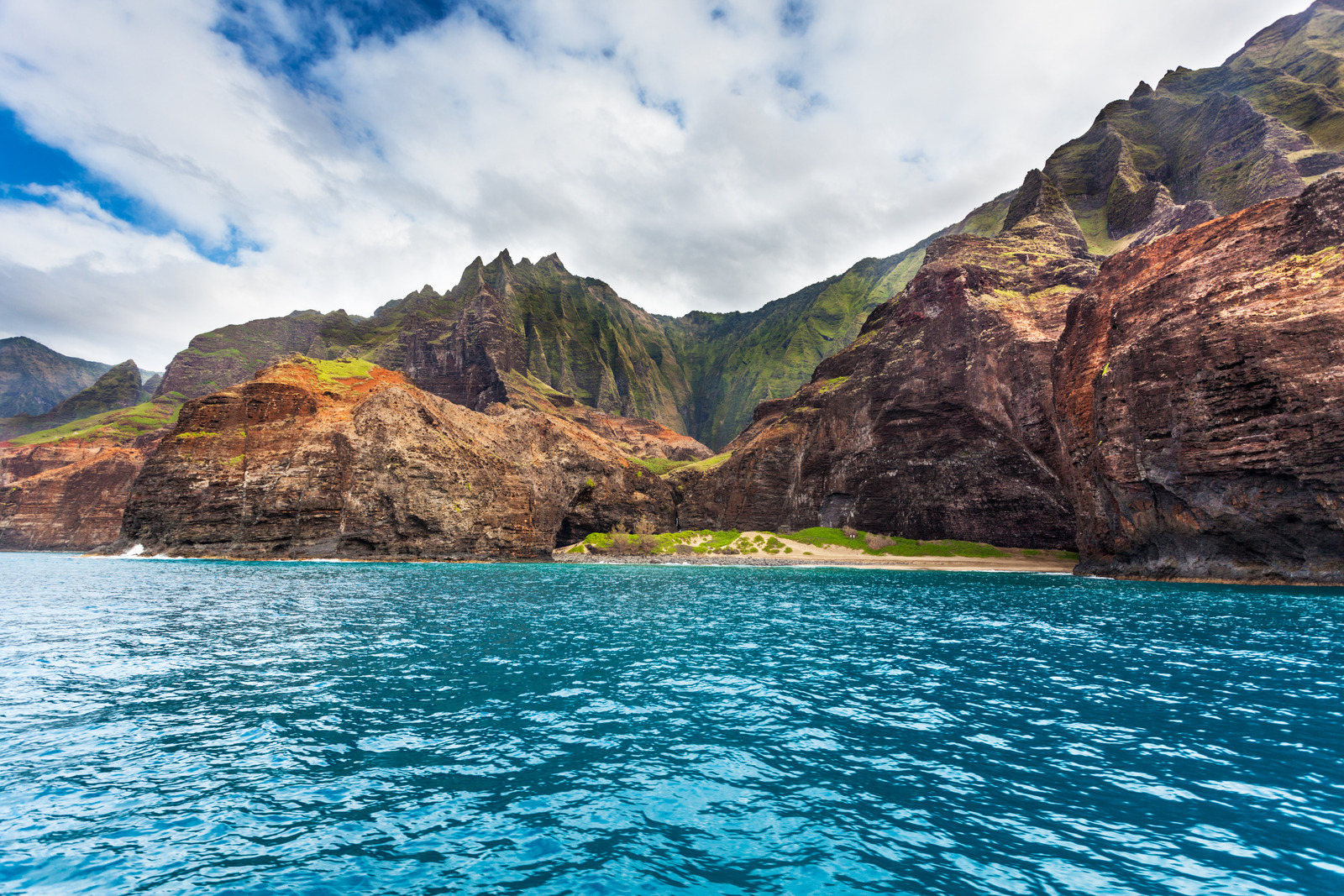 Honopu Beach, Kauai, Hawaii – Remote golden sand and natural rock arch at Honopu Beach, Kauai, Hawaii.