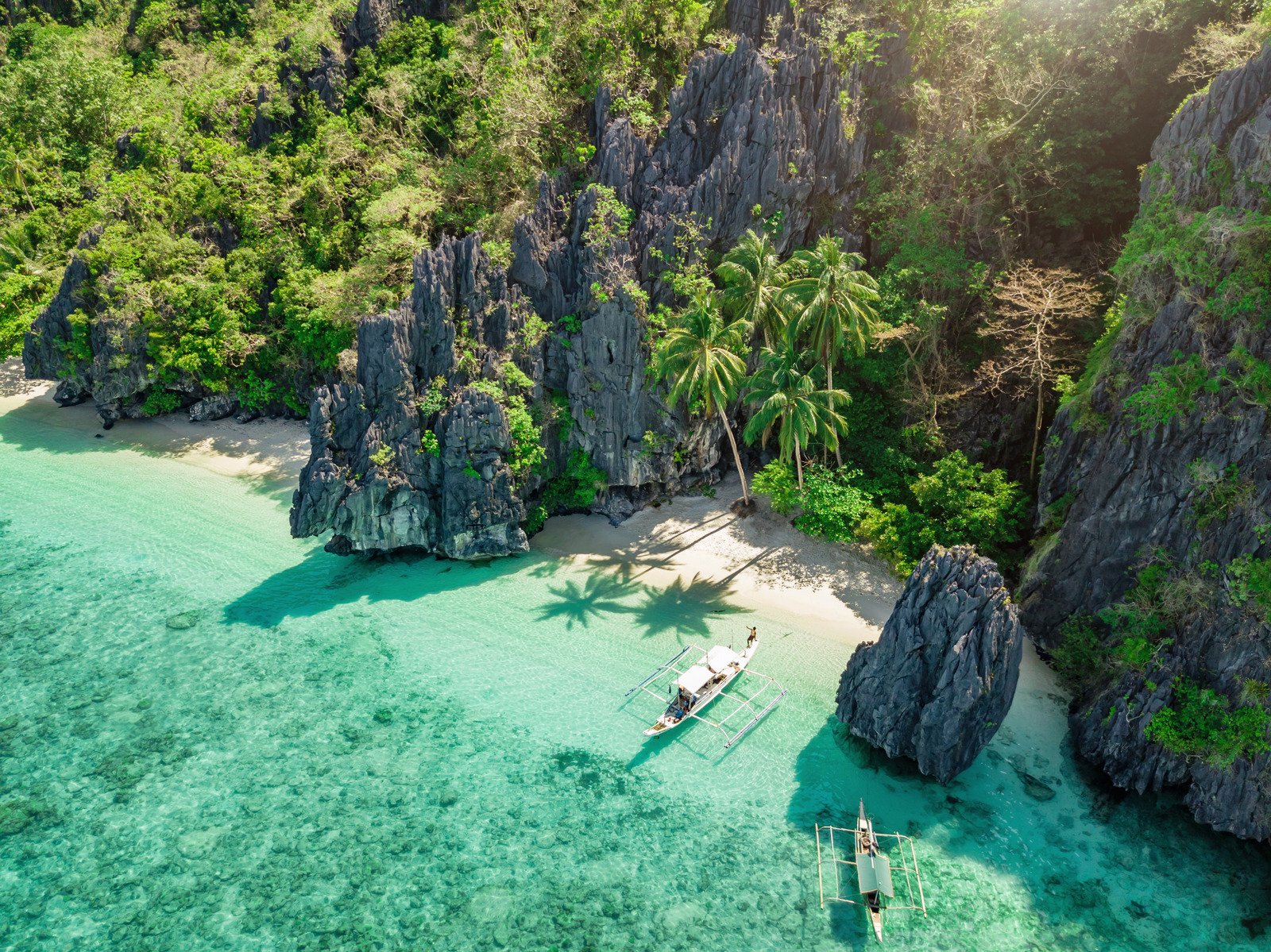 Ipil Beach, El Nido, Palawan Island, Philippines – Glass-like water and mountain backdrop at Ipil Beach, El Nido, Palawan.