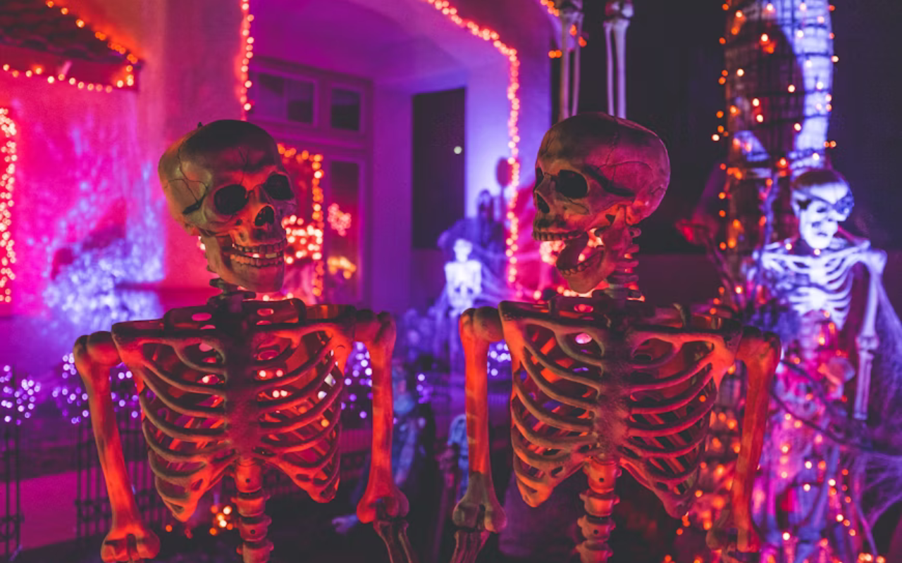Halloween skeleton decorations glowing under purple and orange lights in Cynthiana, Kentucky, celebrating the town’s Walking Dead connection and spooky festivities.