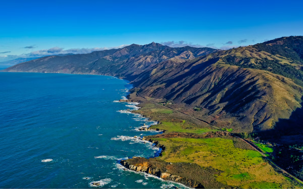 Scenic aerial view of Big Sur California coastline with rugged cliffs and blue ocean waves, a U.S. destination that feels like Italy’s Amalfi Coast