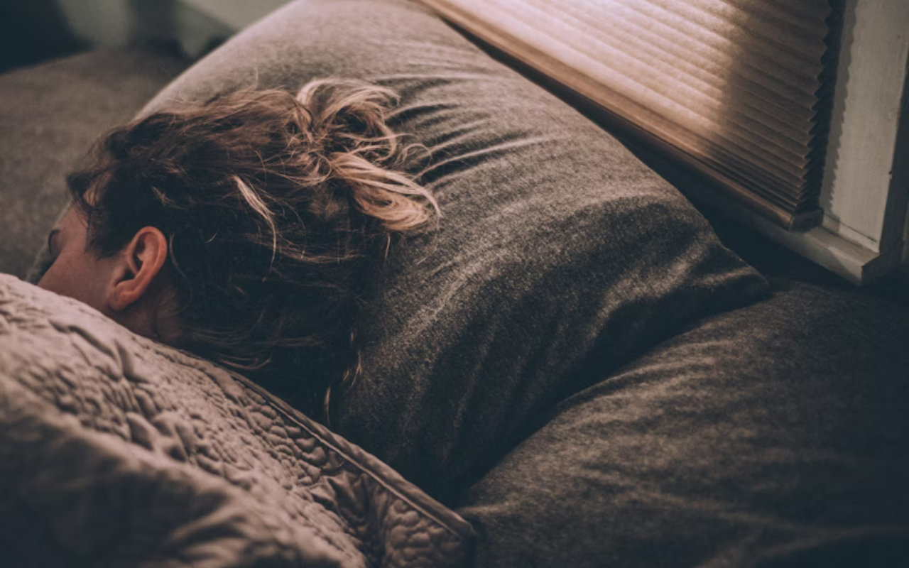 Young woman sleeping comfortably in bed
