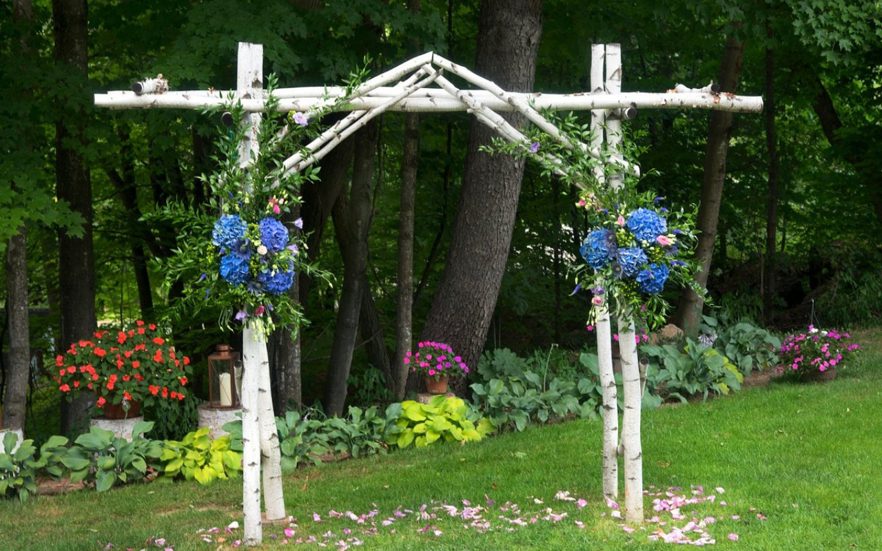Floral archway in a garden setting in Jackson, New Hampshire, a U.S. town with countryside charm like England’s Cotswolds